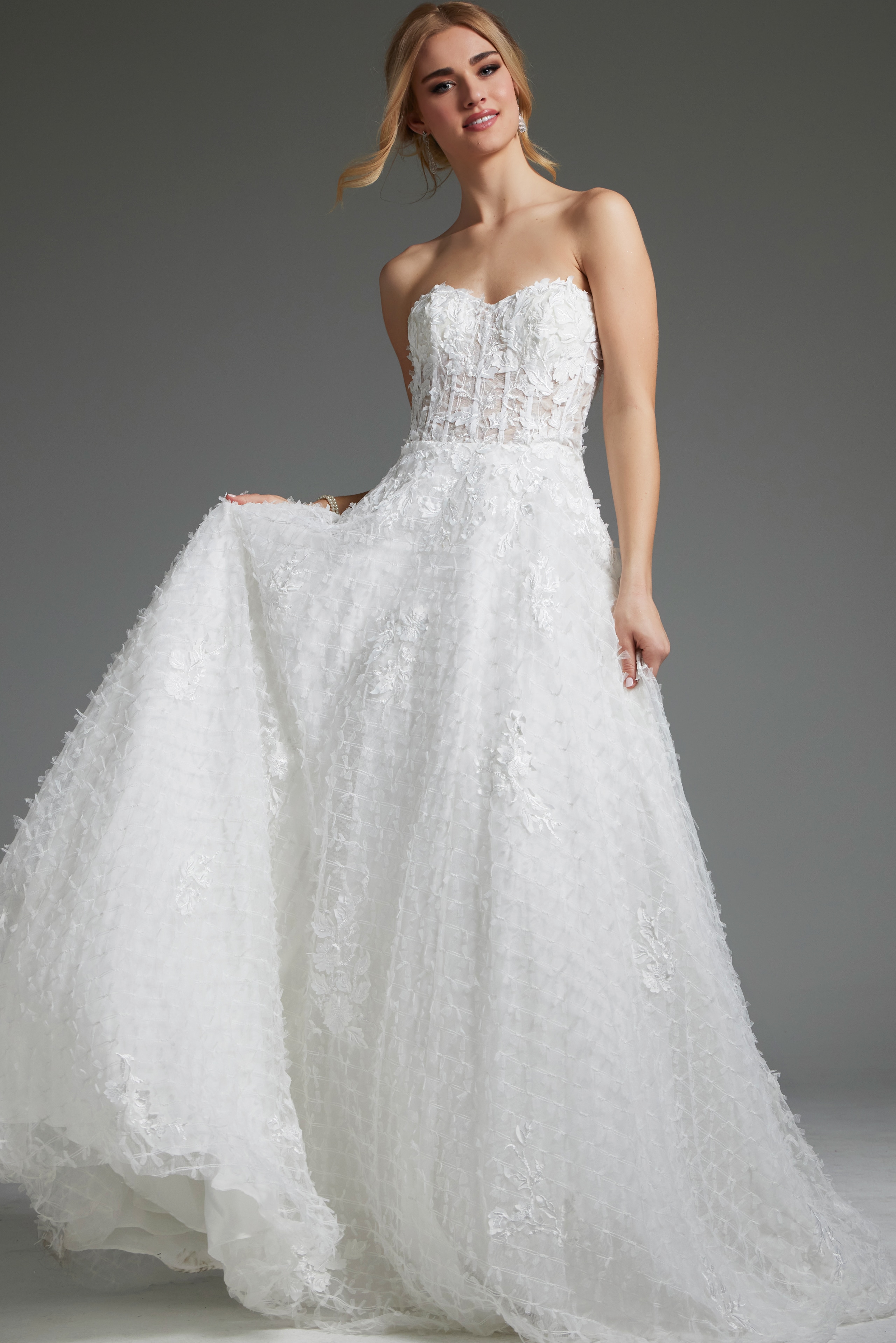 Model wearing Jovani JB07165 white gown with floral appliqué and sweetheart neckline, front view.
