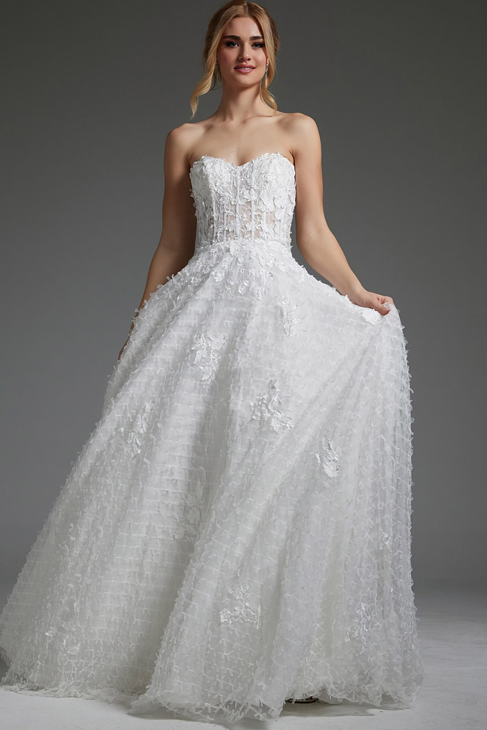 Model wearing Jovani JB07165 white gown with intricate floral patterns, front view.