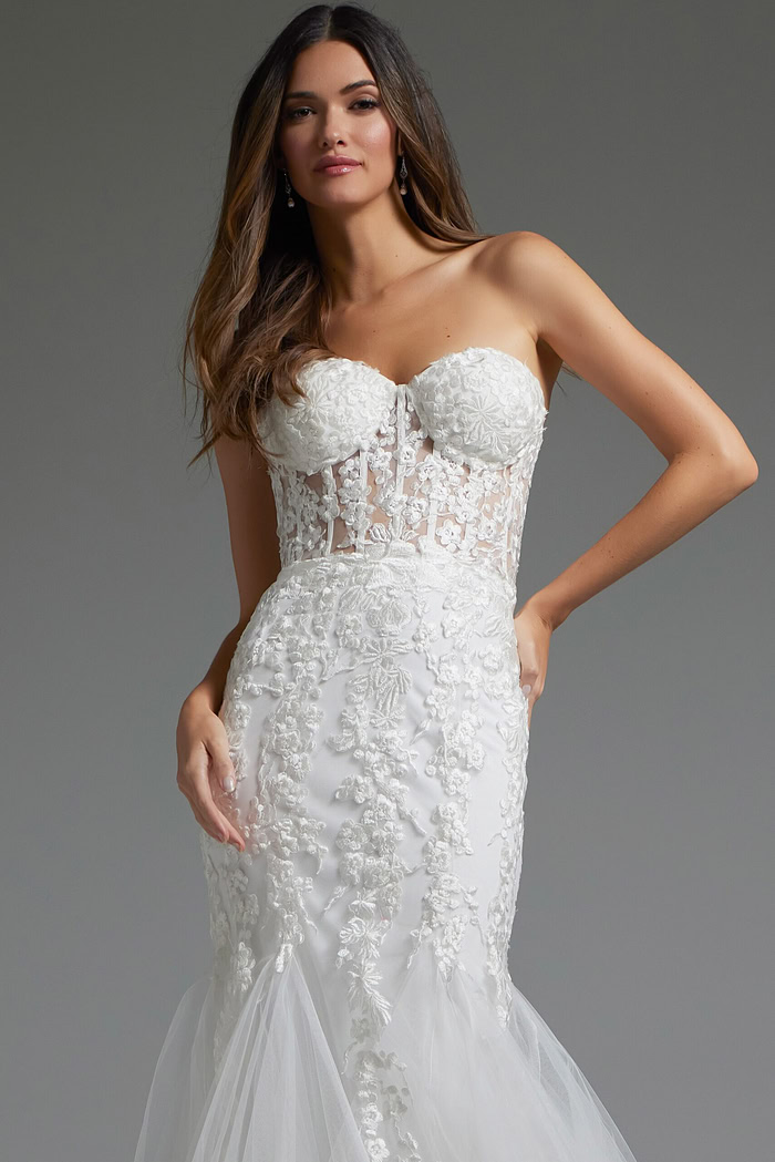 Close-up of model in Jovani JB07260 gown, showing strapless neckline and floral embroidery.