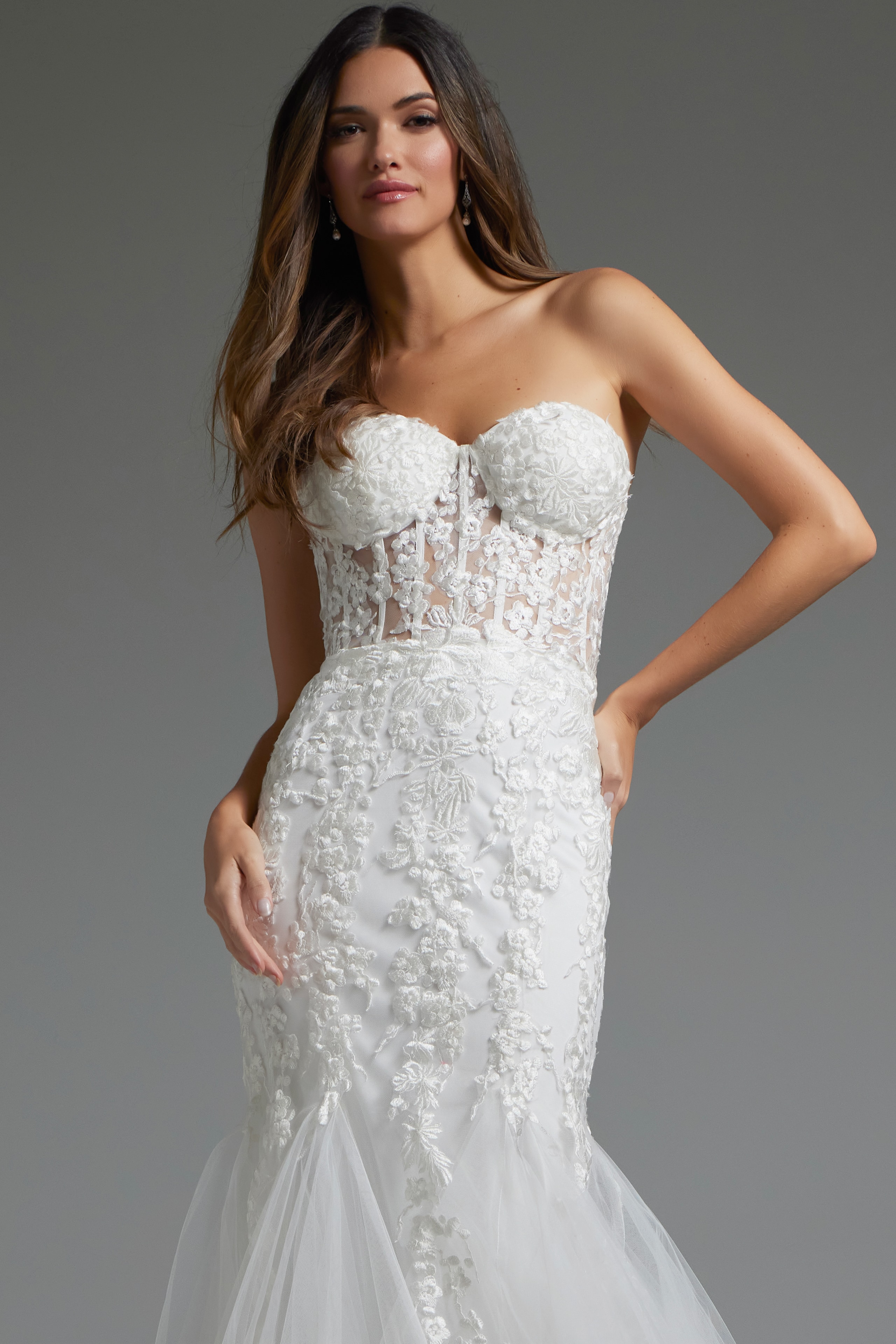 Close-up of model in Jovani JB07260 gown, showing strapless neckline and floral embroidery.