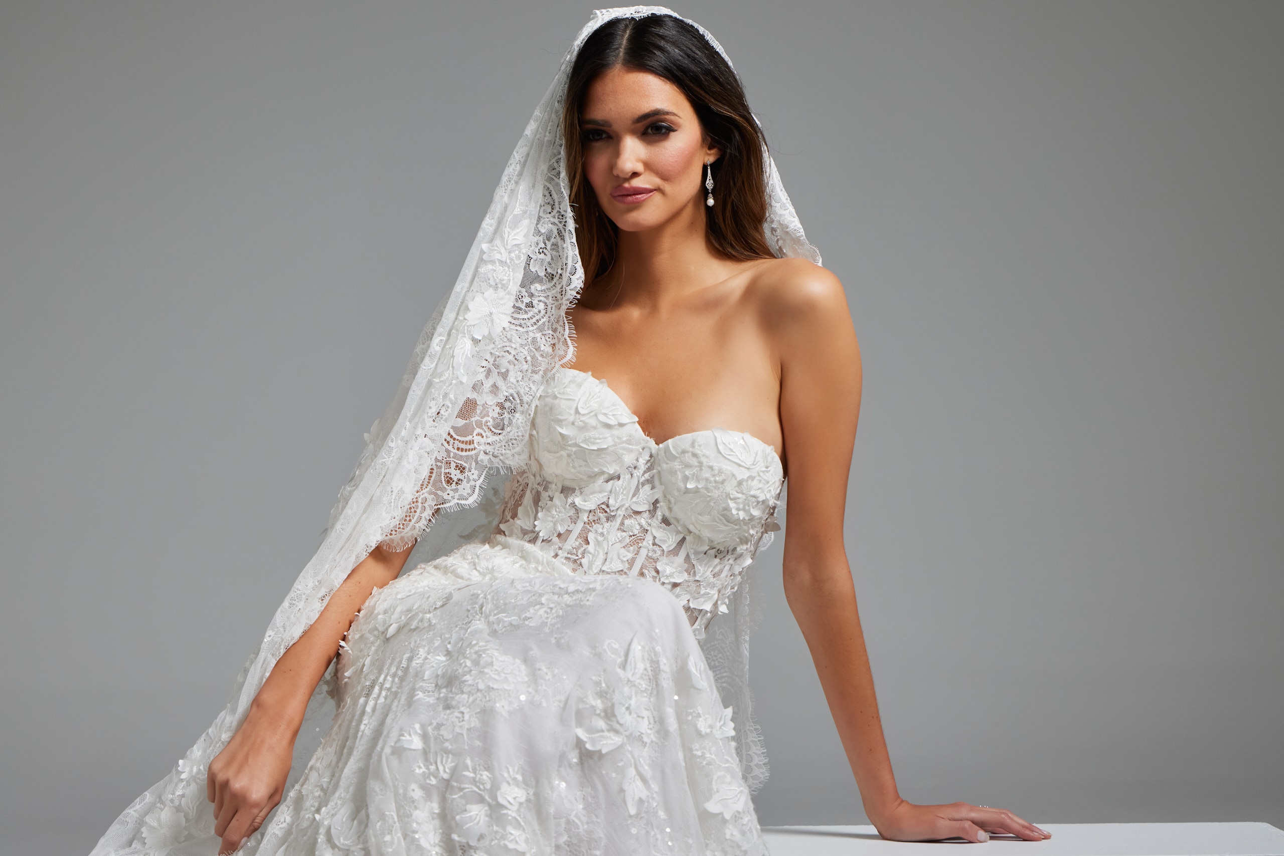 Jovani JB07583 white gown showcased with intricate lace and strapless design.