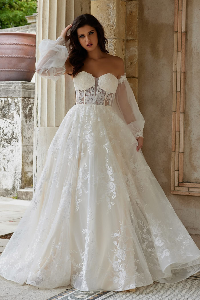 Model in Jovani JB220004 ivory gown with elegant embroidered skirt, front view.