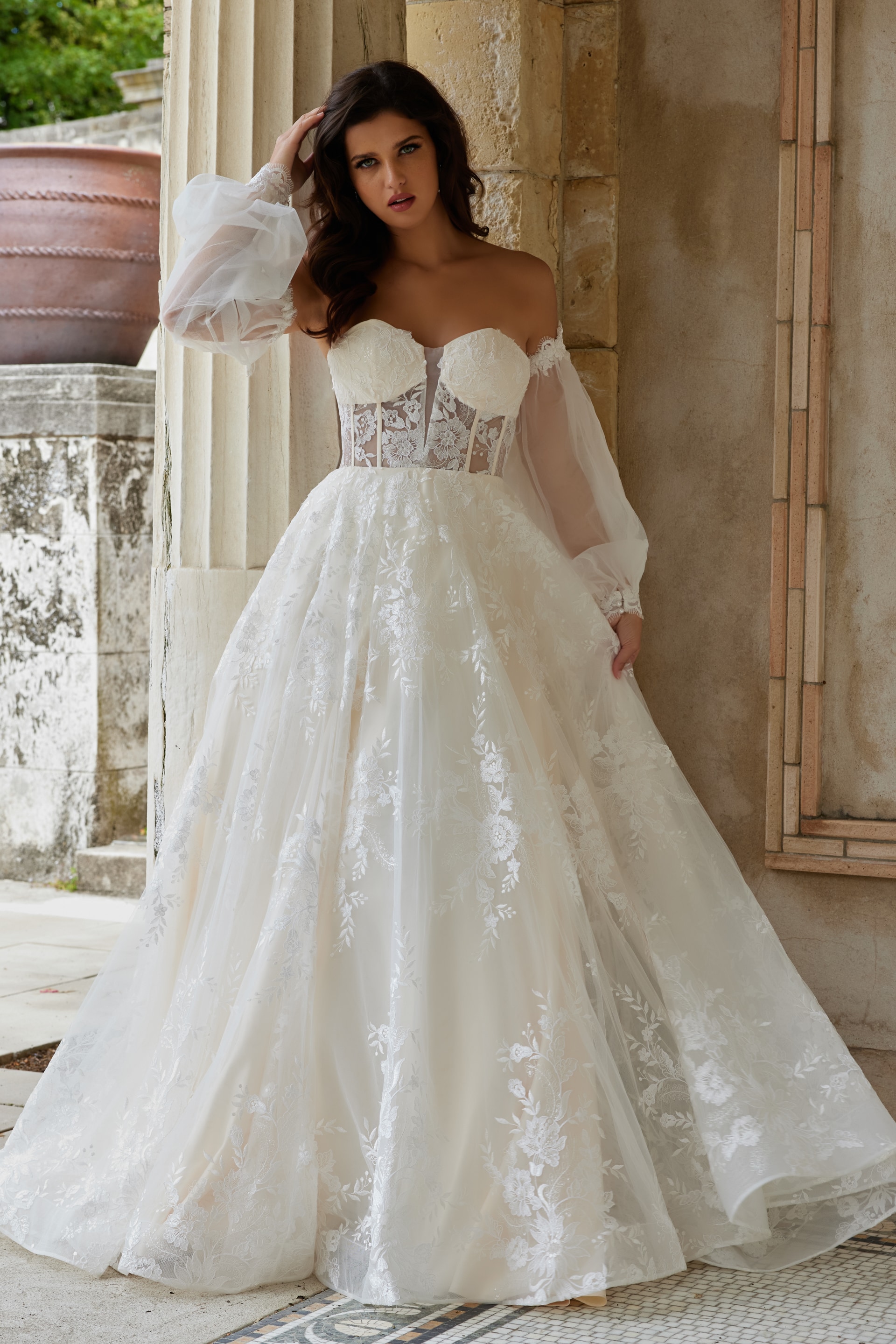 Model in Jovani JB220004 ivory gown with elegant embroidered skirt, front view.