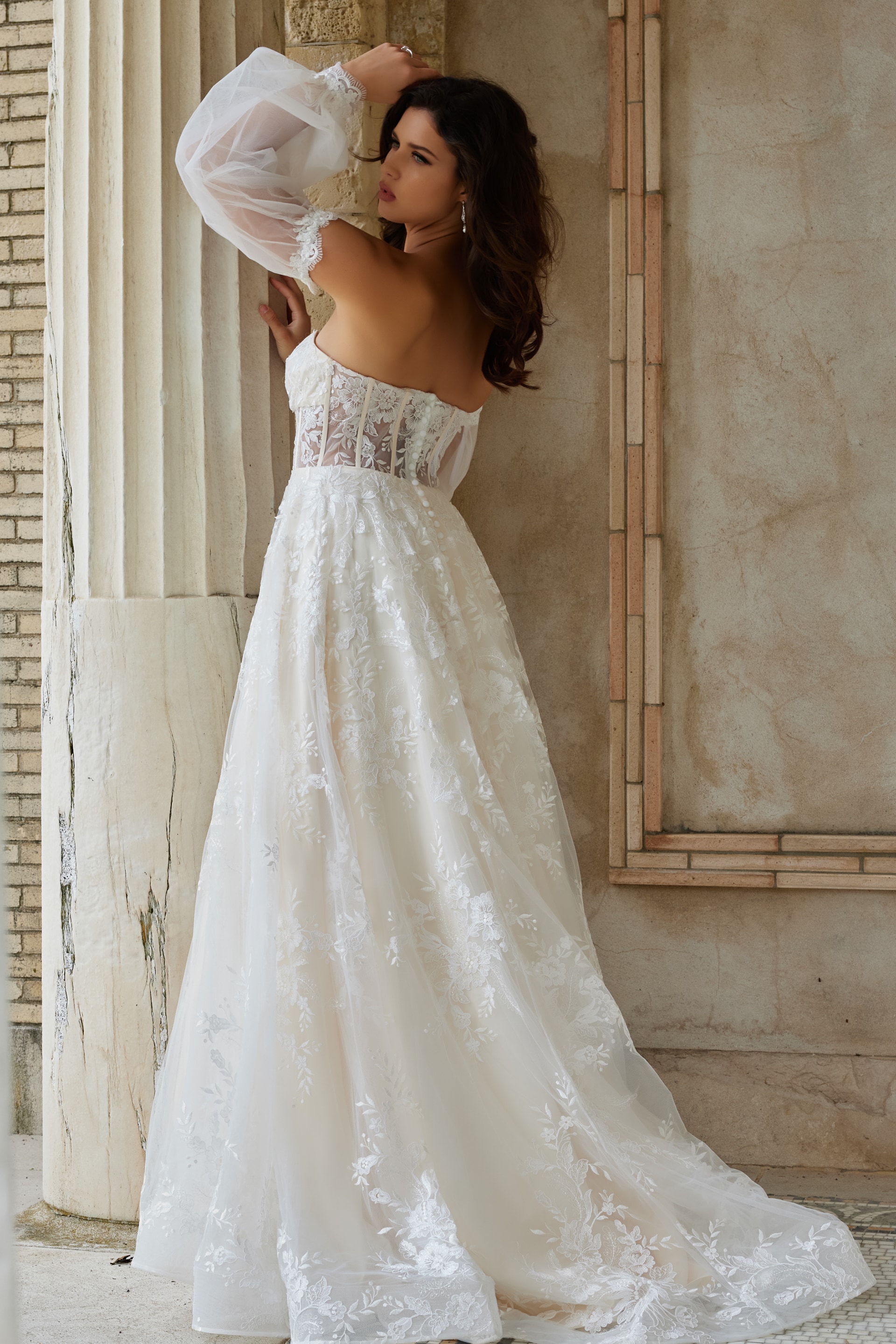 Model wearing Jovani JB220004 ivory gown, back view displaying sheer panels.