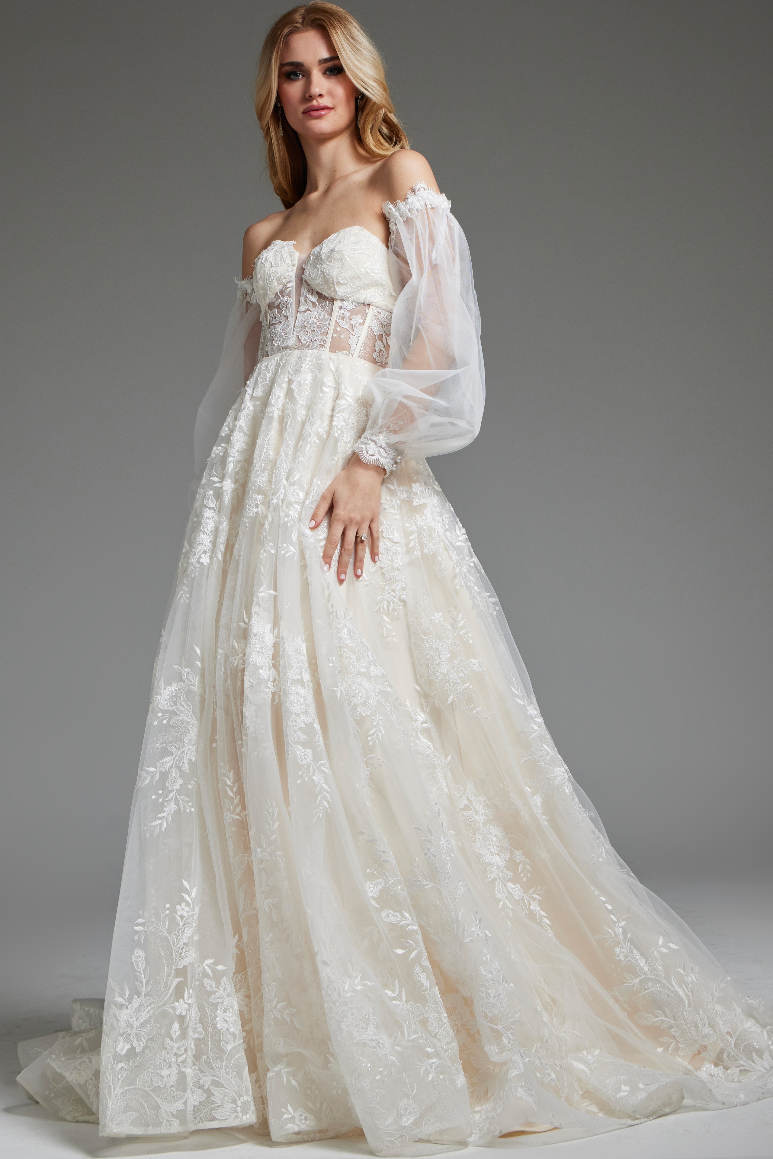Model in Jovani JB220004 ivory dress featuring beautiful lace embroidery, front view.
