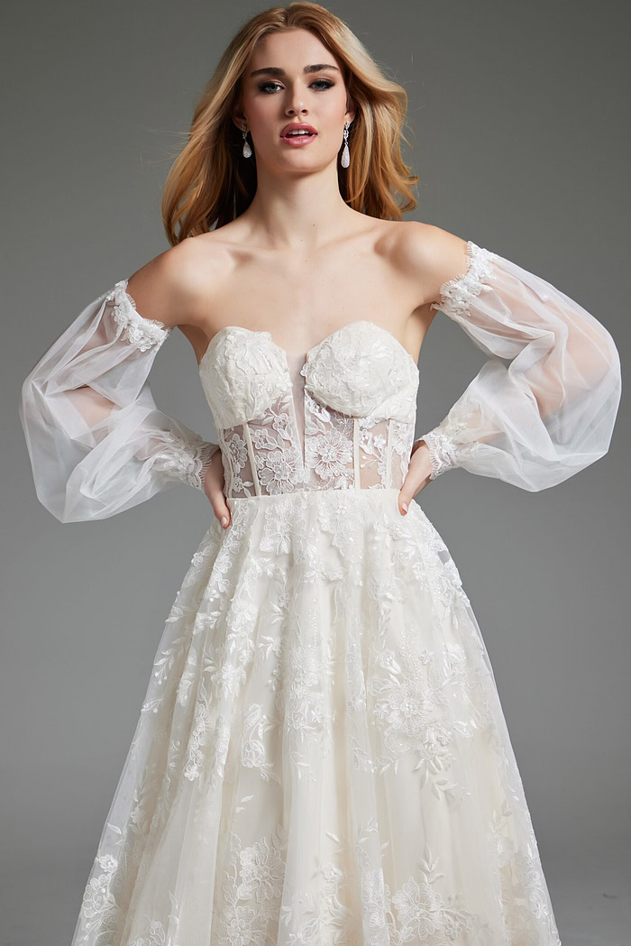 Model wearing Jovani JB220004 ivory gown with elegant sheer sleeves, close-up view.