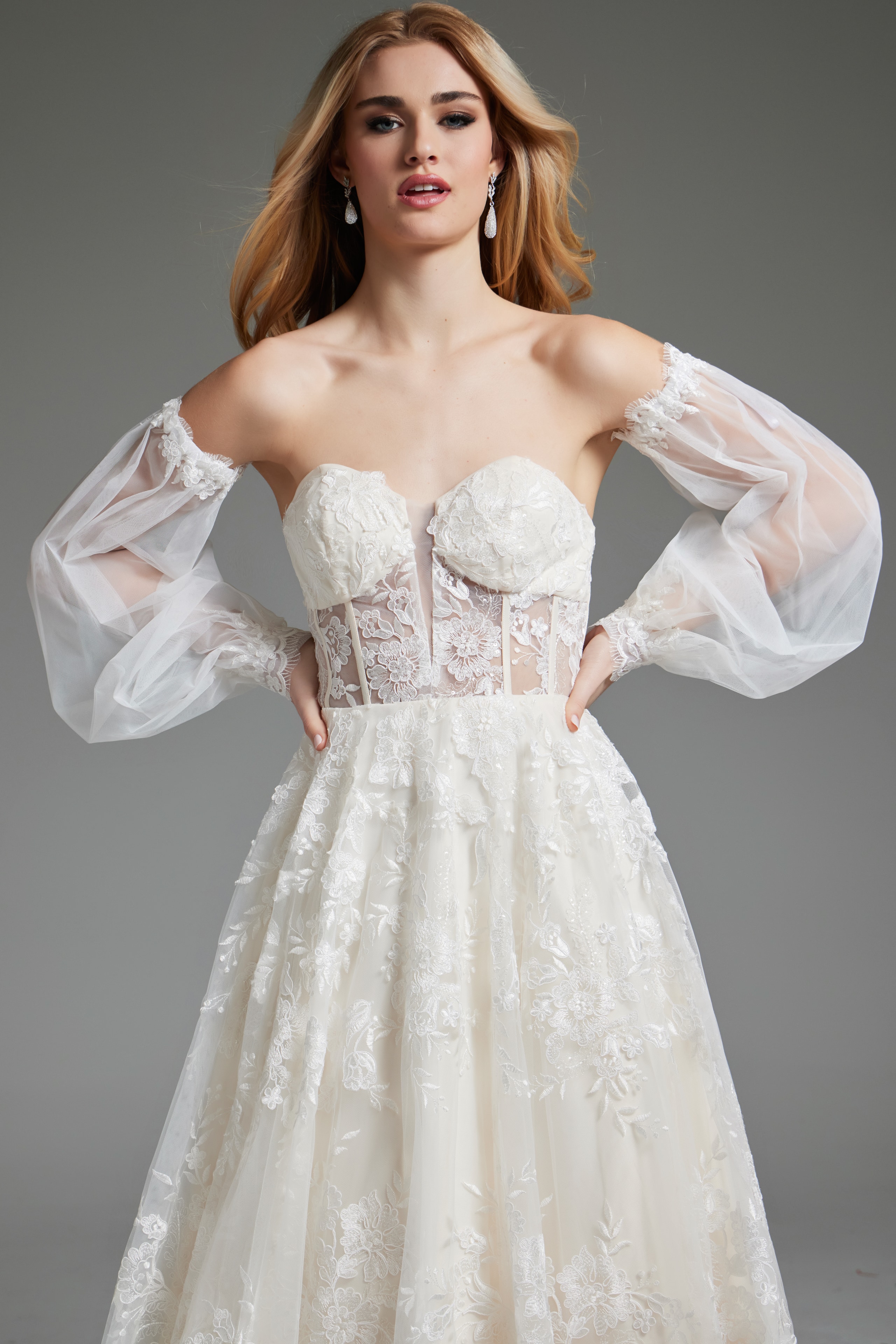 Model wearing Jovani JB220004 ivory gown with elegant sheer sleeves, close-up view.