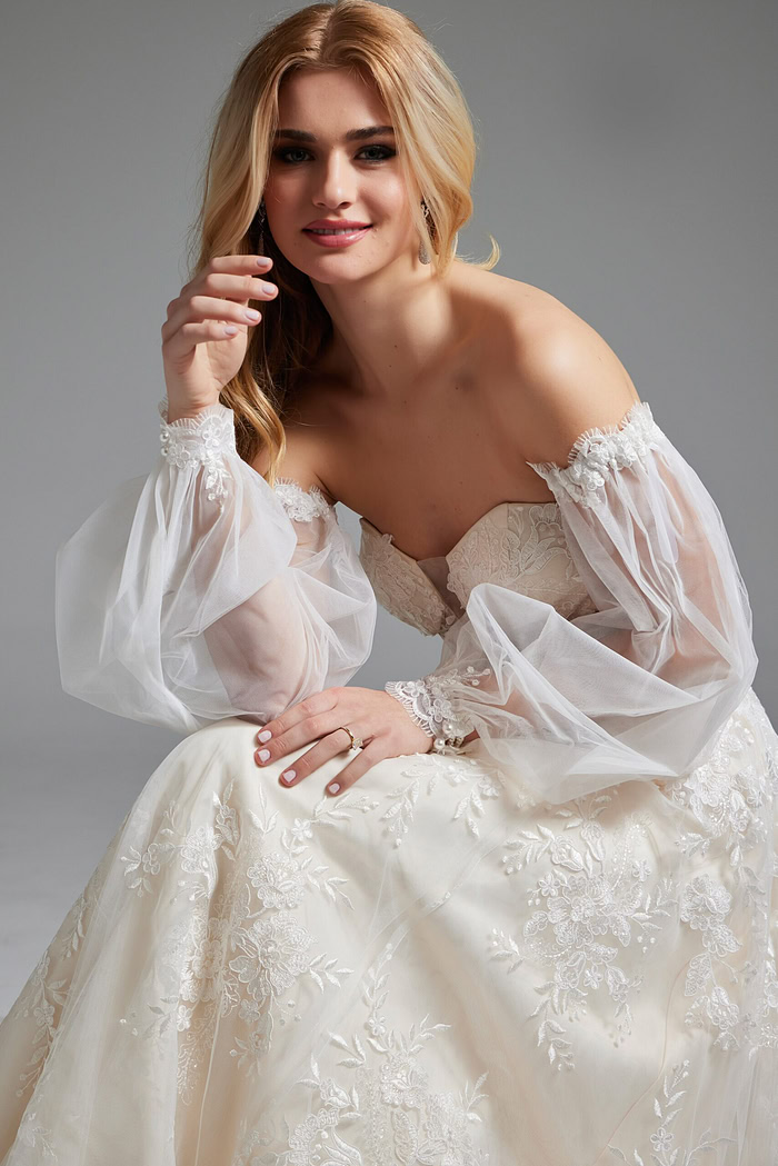 Model showcasing Jovani JB220004 ivory gown with intricate floral lace, front view.