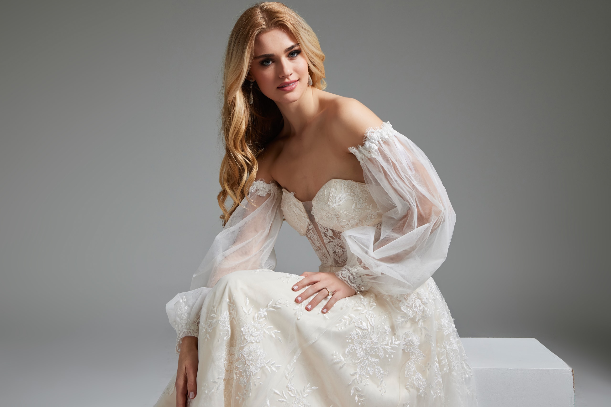 Model in Jovani JB220004 ivory gown, back view highlighting the sheer back design.