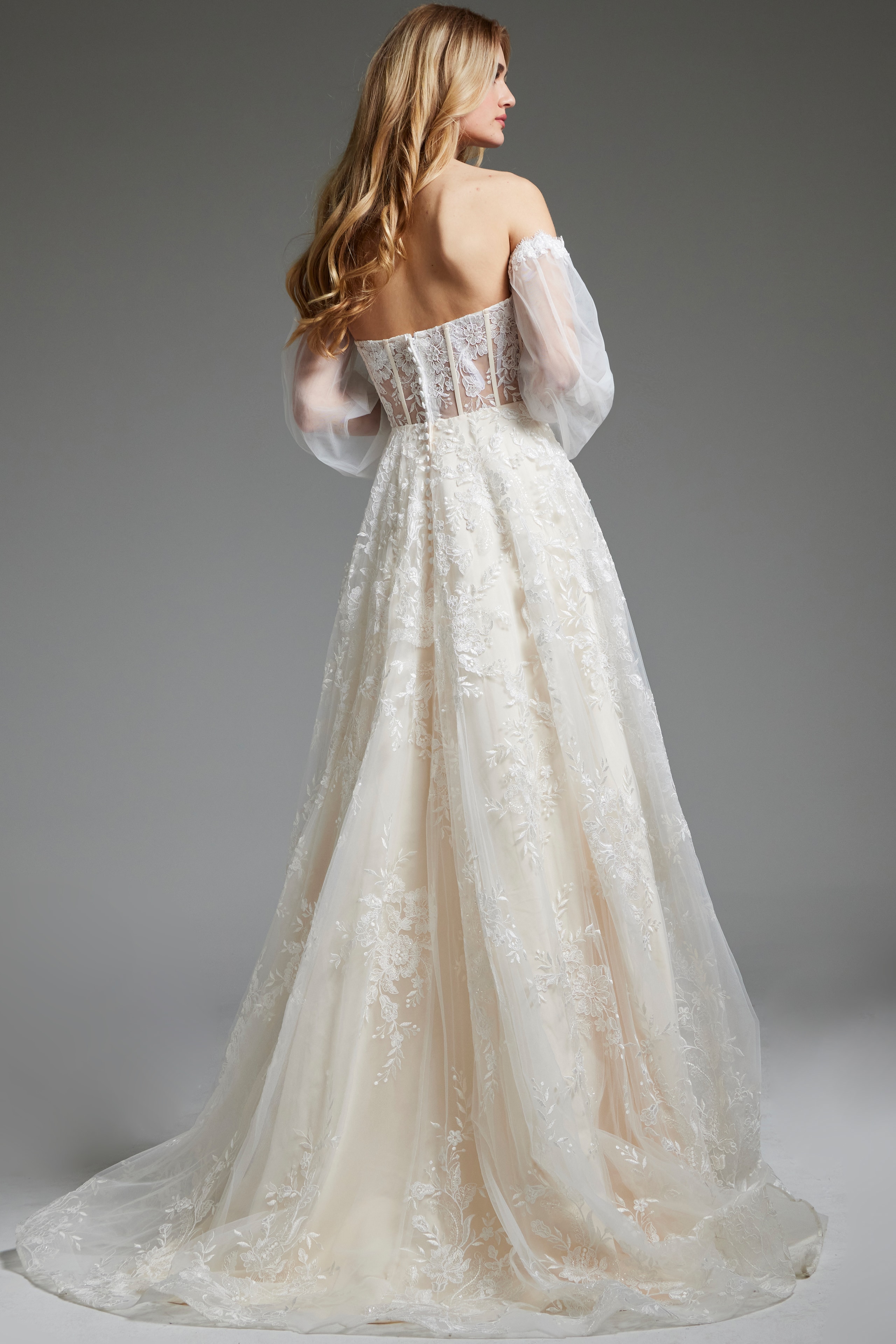 Model wearing Jovani JB220004 ivory gown with off-the-shoulder detail, front view.