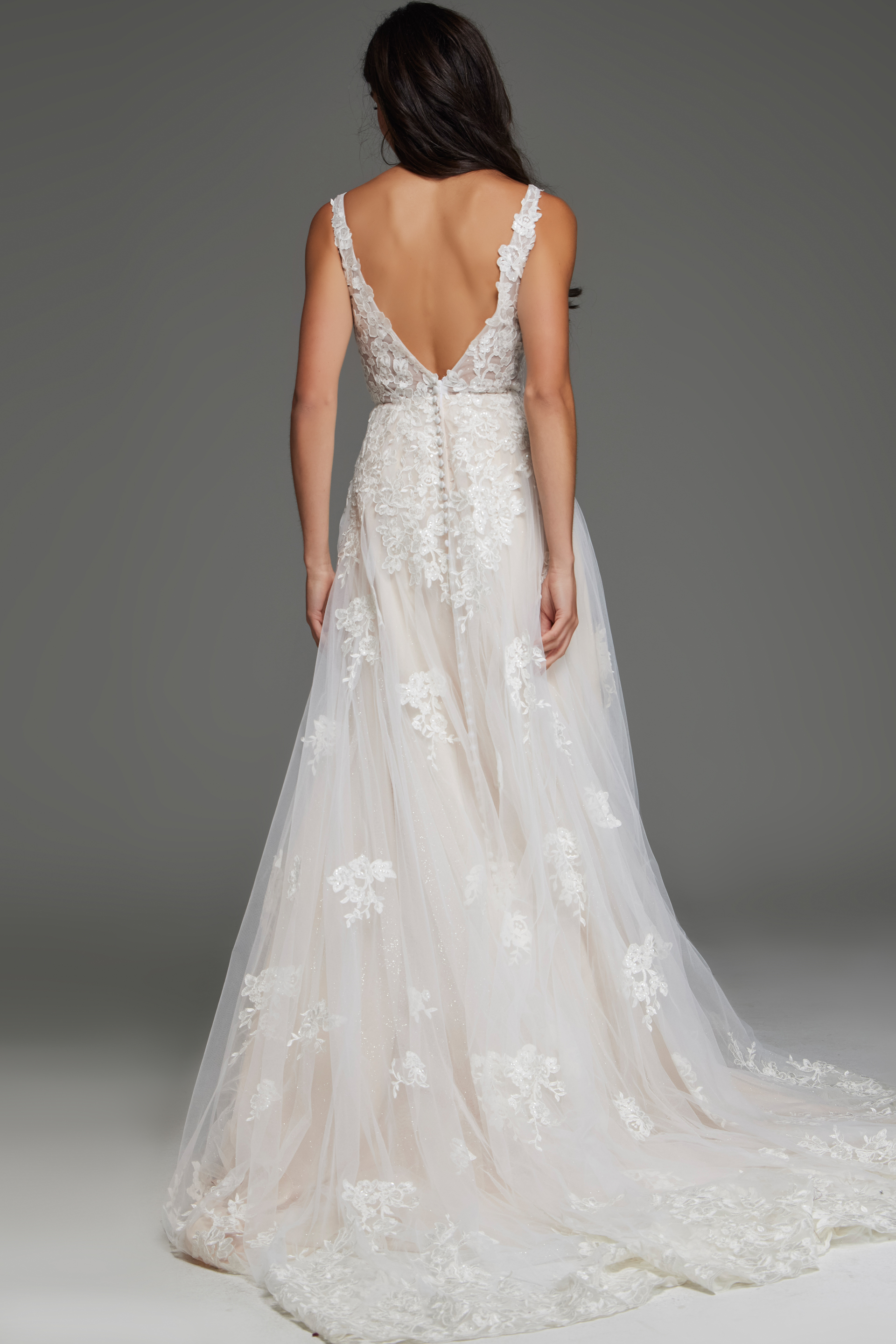 Back view of model wearing Jovani JB220005 ivory dress with lace appliqué