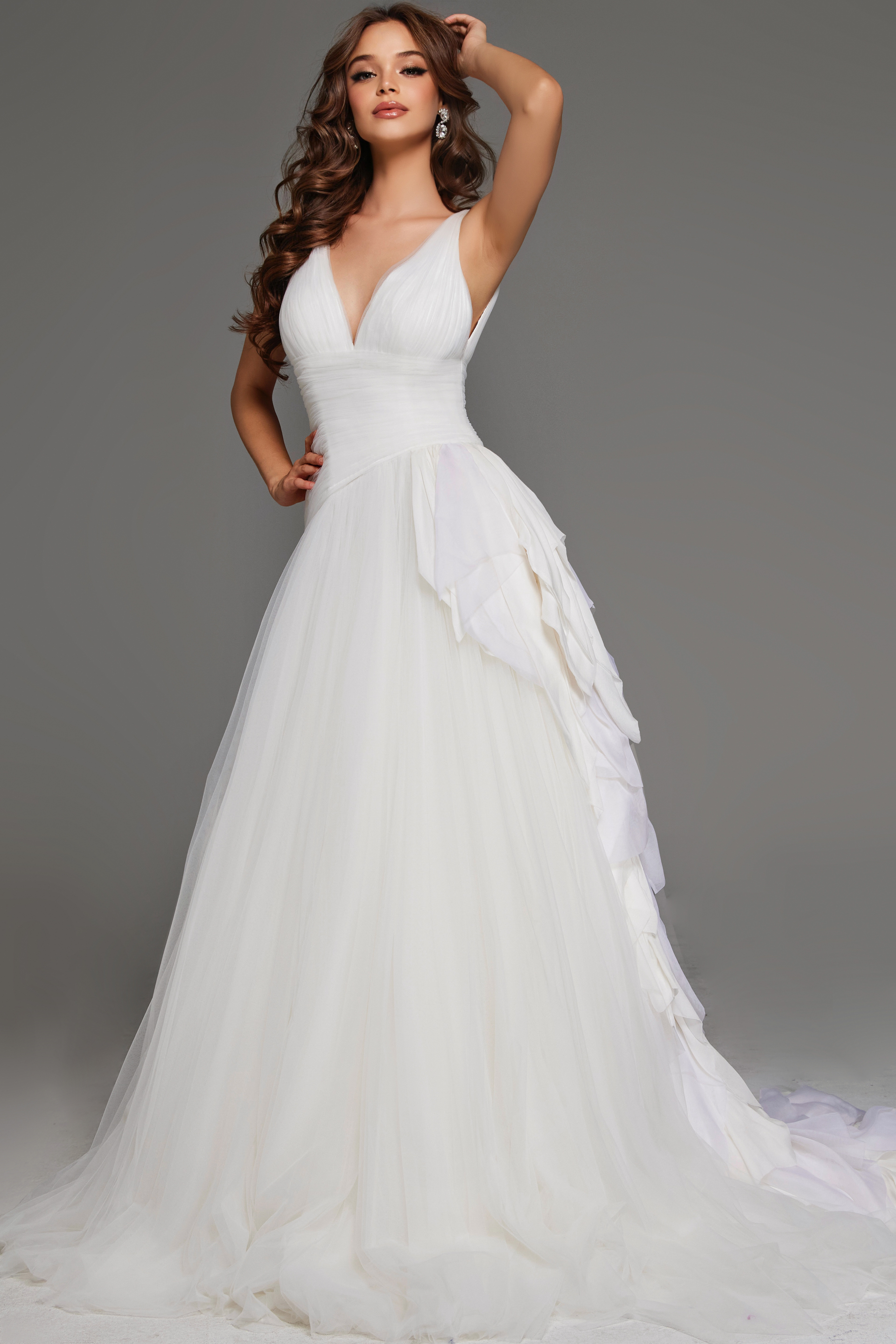Model wearing Jovani JB23241 white A-line gown with deep V-neck and cascading ruffles.