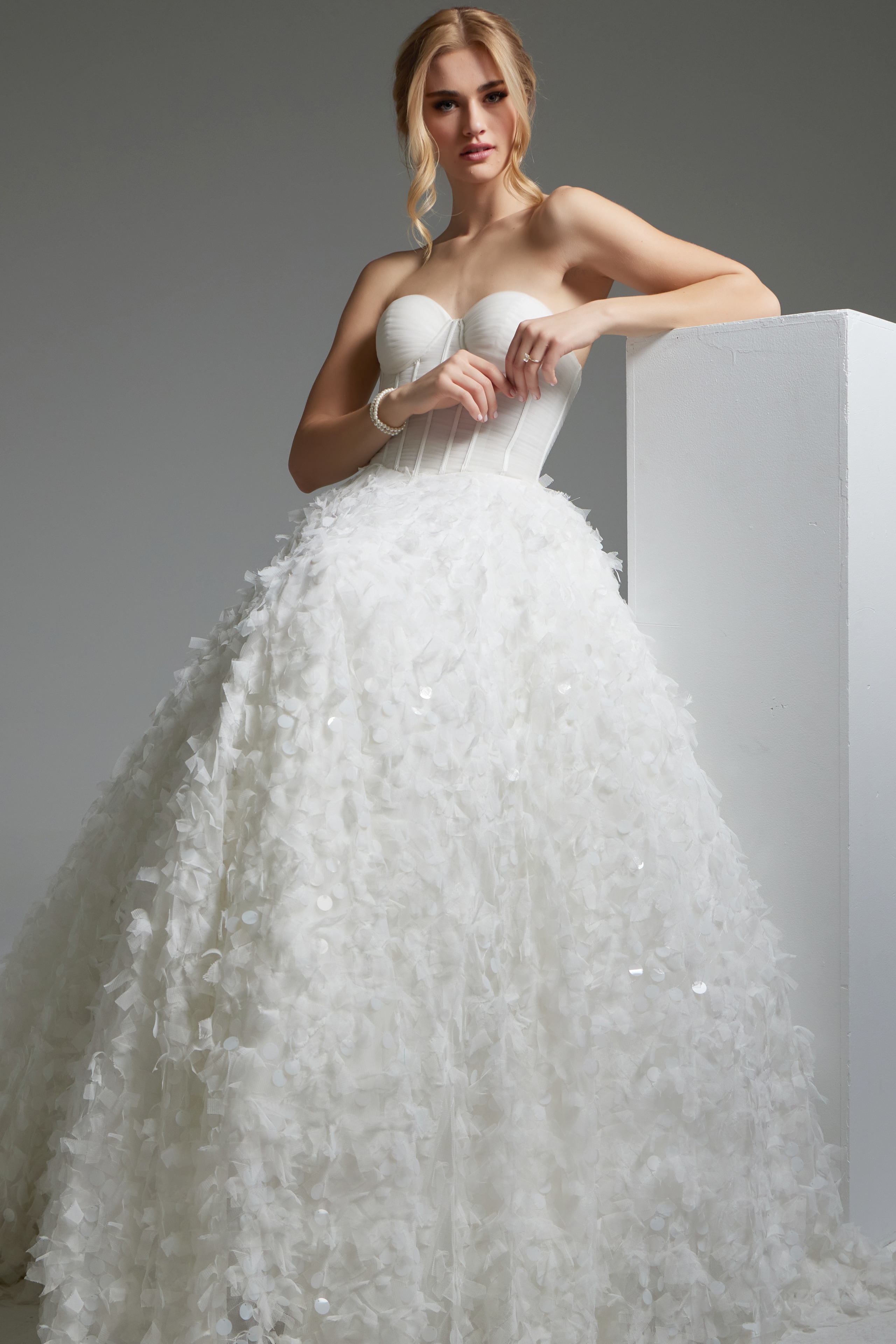 model wearing Jovani JB26295 A-line white dress detailed with floral appliqué