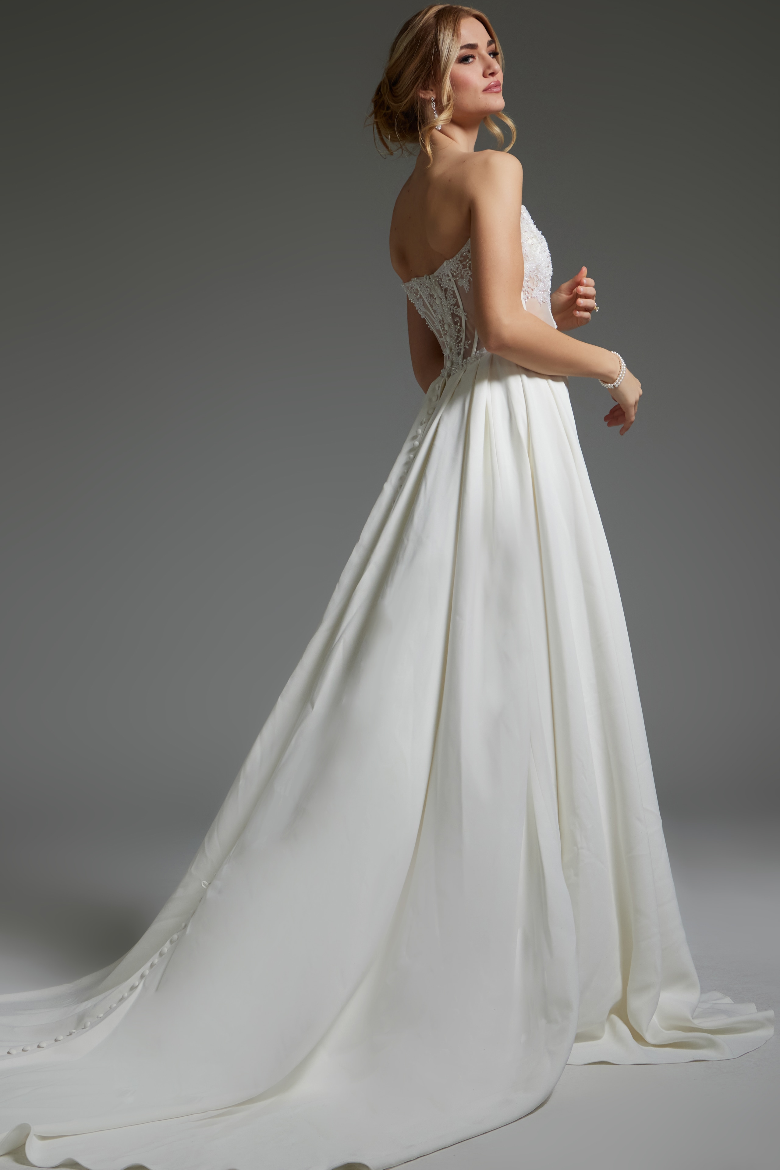 Back view of Jovani JB37128 ivory dress with buttoned closure and long train.