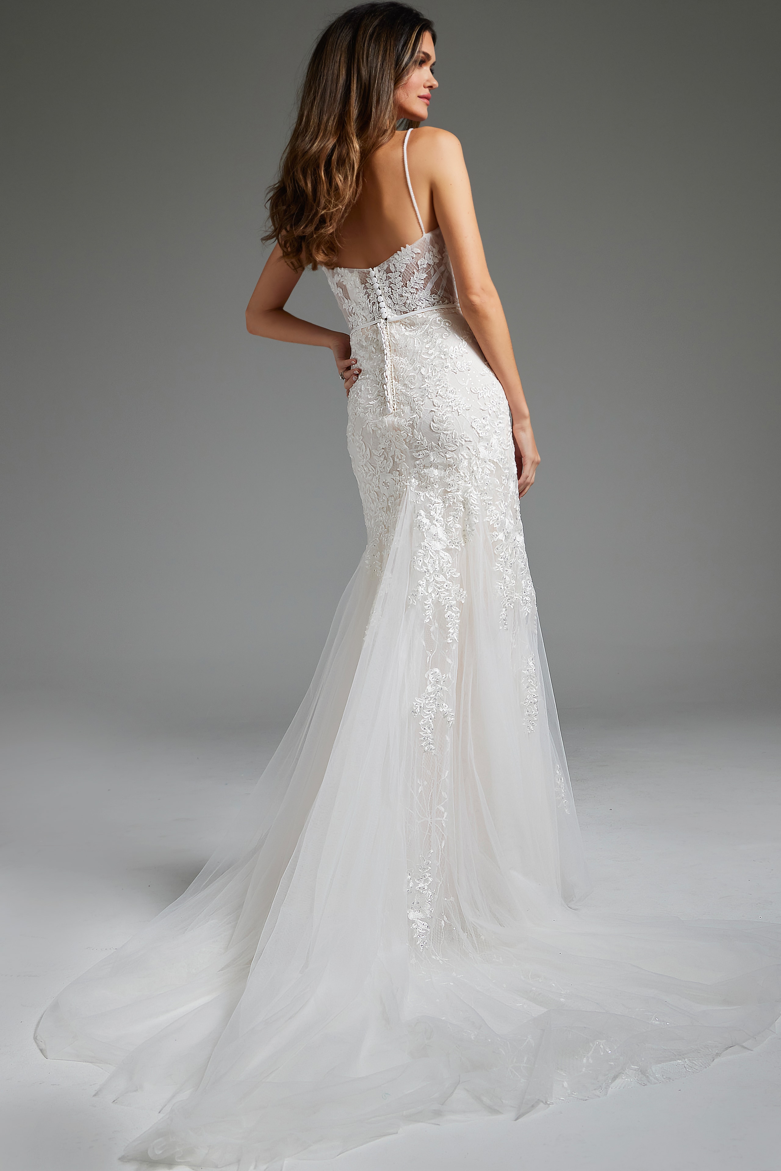 Model wearing Jovani JB38490, back view, showing delicate lace and train detail.