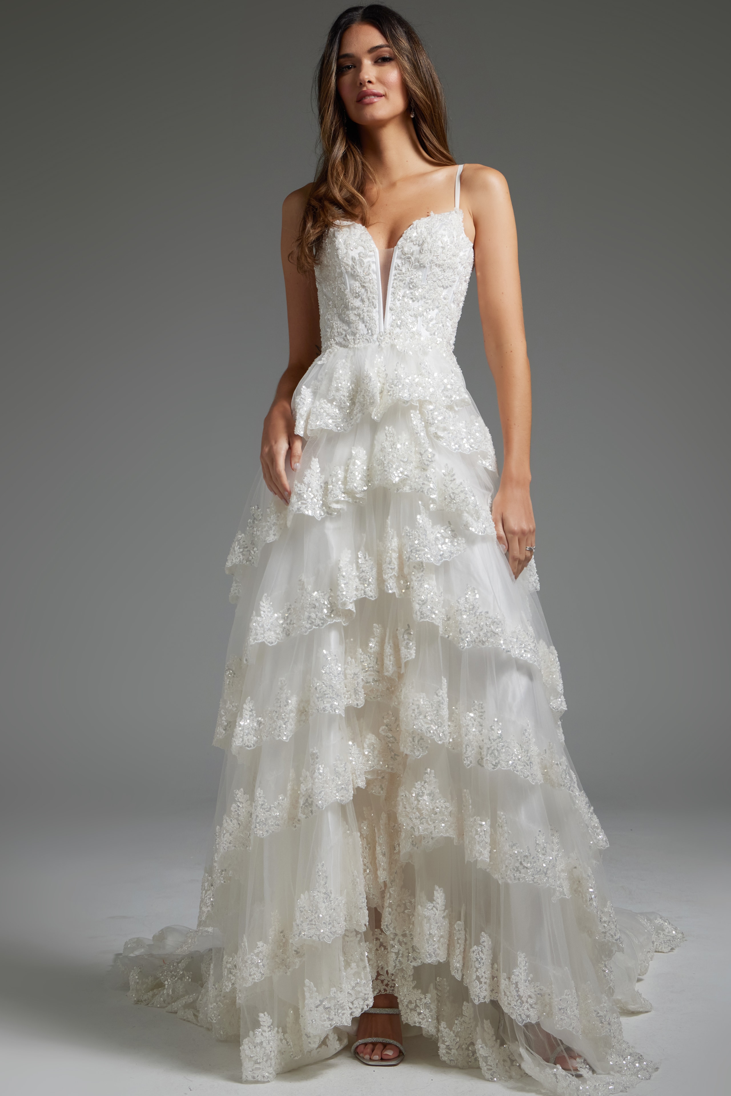 Model wearing JB38641 white dress, front view with layered skirt and sweetheart neckline.