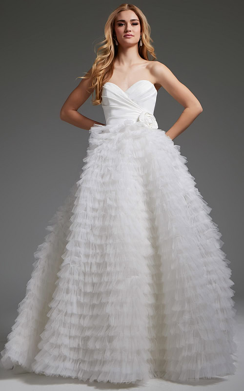 Model wearing Jovani JB38958 white gown with sweetheart neckline and ruffled skirt.