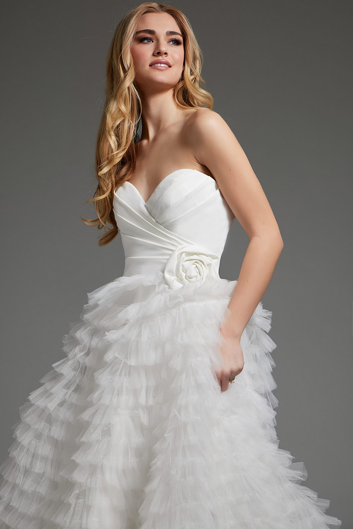 Model wearing Jovani JB38958 white gown with floral applique detail.