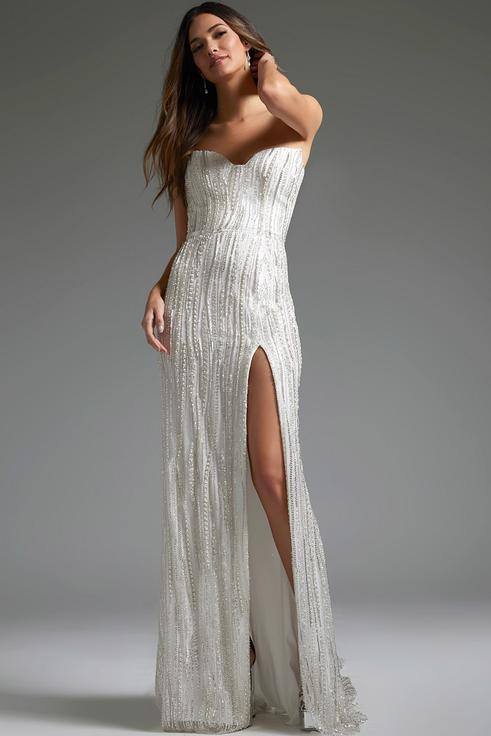 Model in Jovani JB39260 white dress featuring high slit and beadwork.