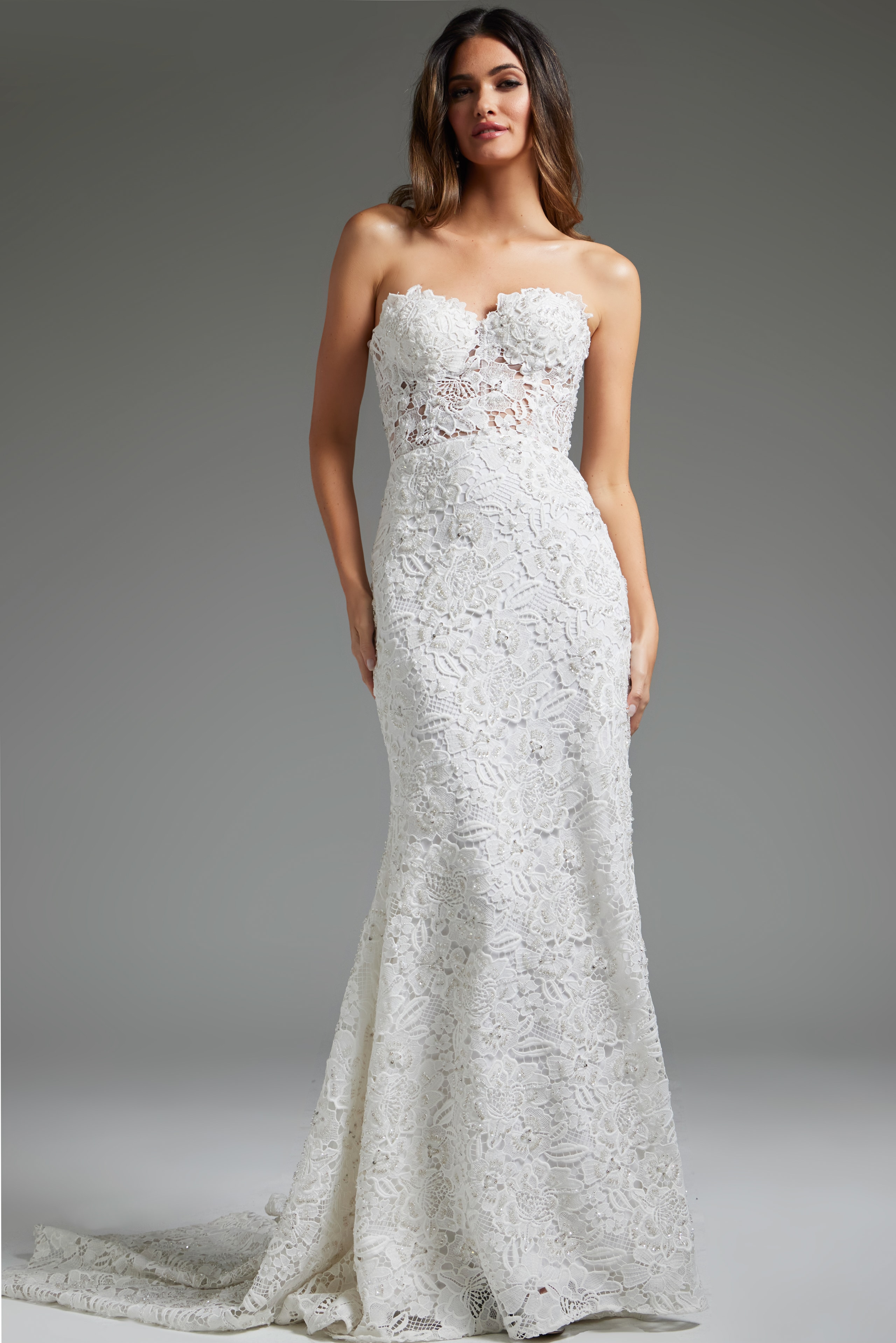 Model wearing Jovani JB39733 white gown, full-length view showcasing lace detail and silhouette.