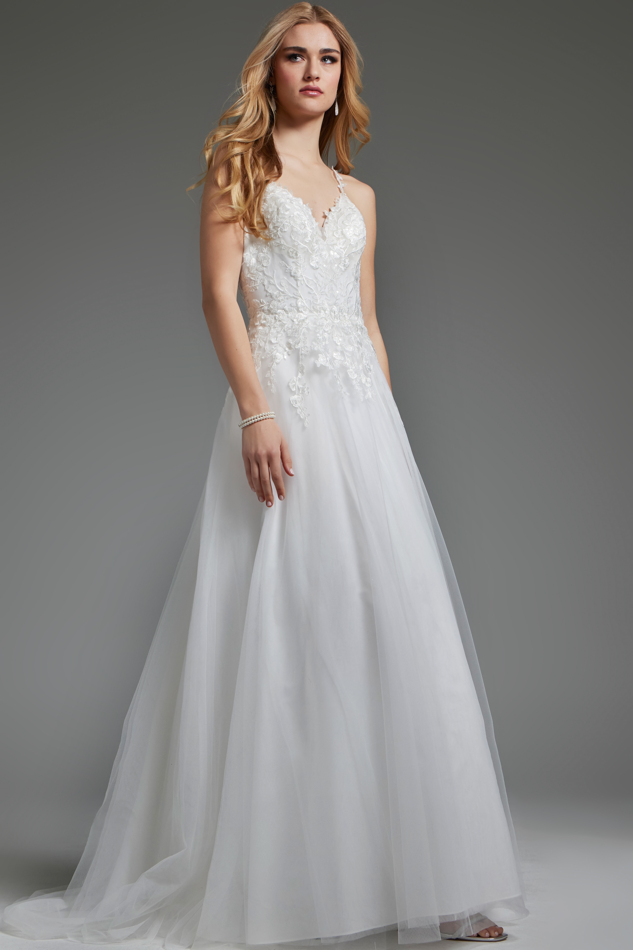 Model in Jovani jb40513 ivory dress with elegant floral lace and A-line shape.