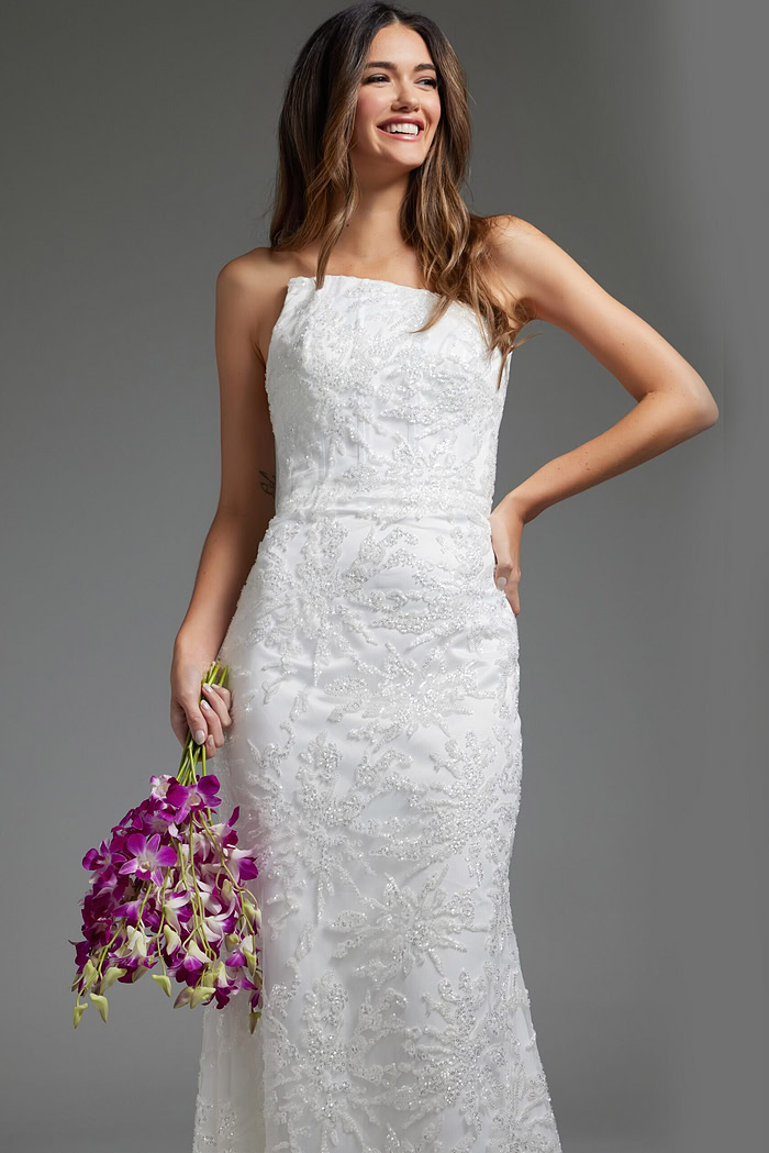 Model wearing JB40608 refined white gown holding flowers, showcasing the elegant lace design