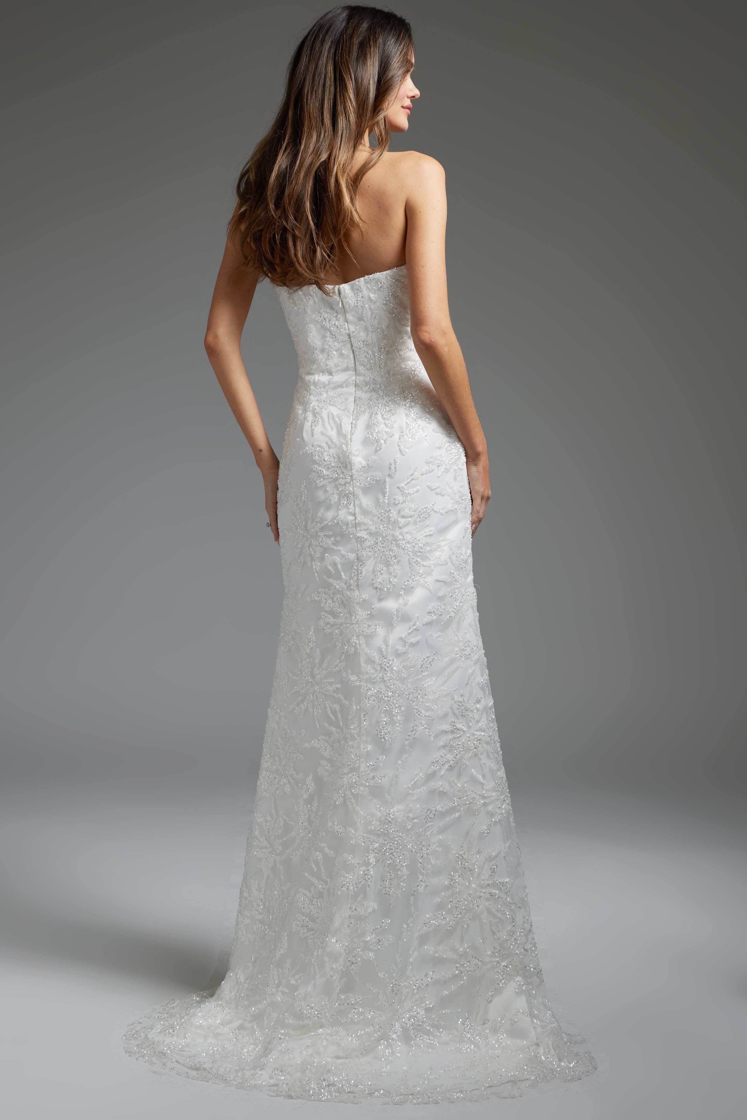 Model wearing JB40608 white gown, back view highlighting the streamlined fit and lace detailing