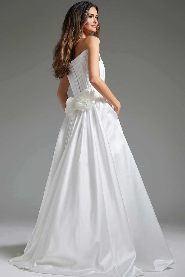 Model wearing Jovani JB40784 white dress from the back, showcasing floral details.