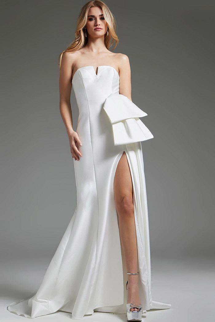 Model wearing Jovani JB40791 white strapless gown with high slit.