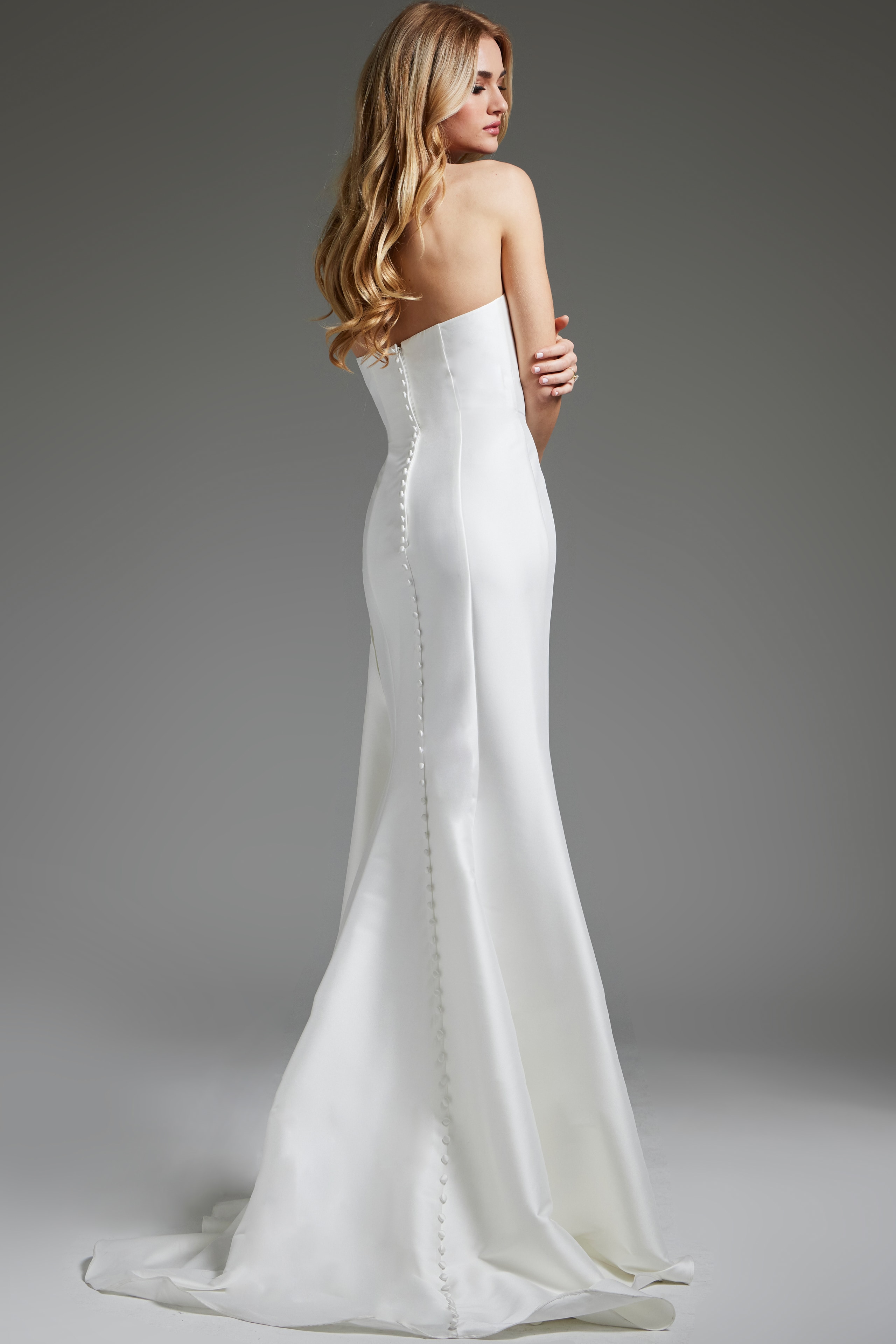 Model showing back of Jovani JB40791 white gown with long train.
