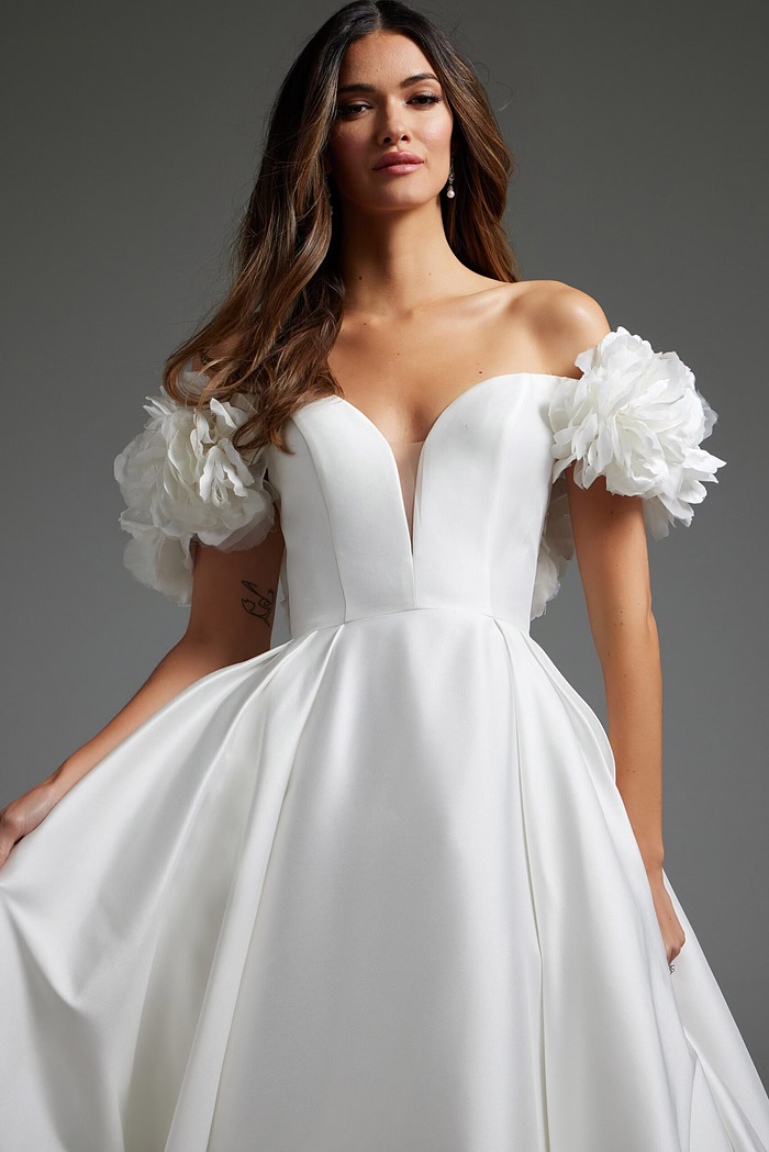 Model wearing Jovani JB40795 off-white gown, front view highlighting neckline.
