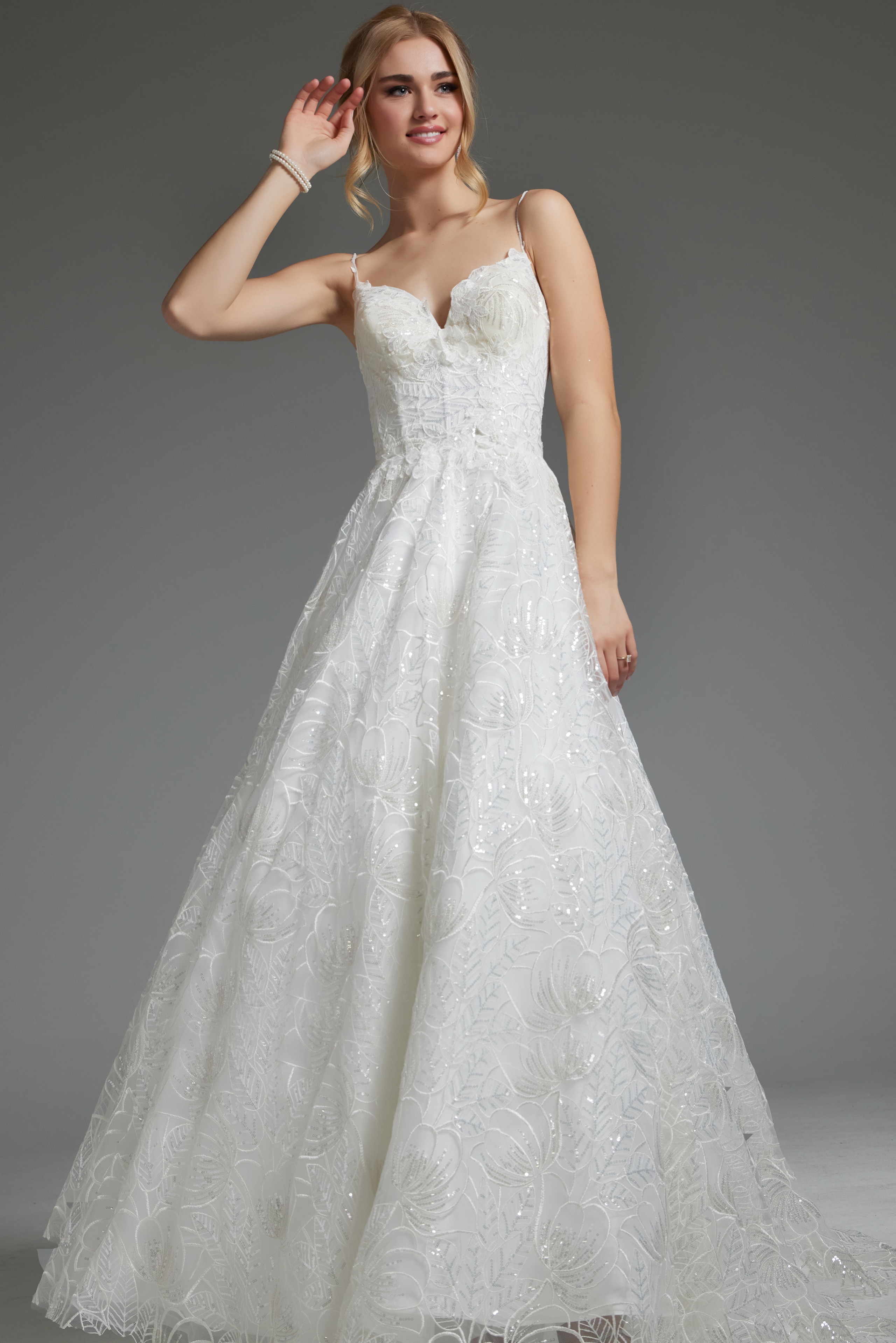 Model in Jovani JB422225 ivory gown with lace details and A-line silhouette, front view.