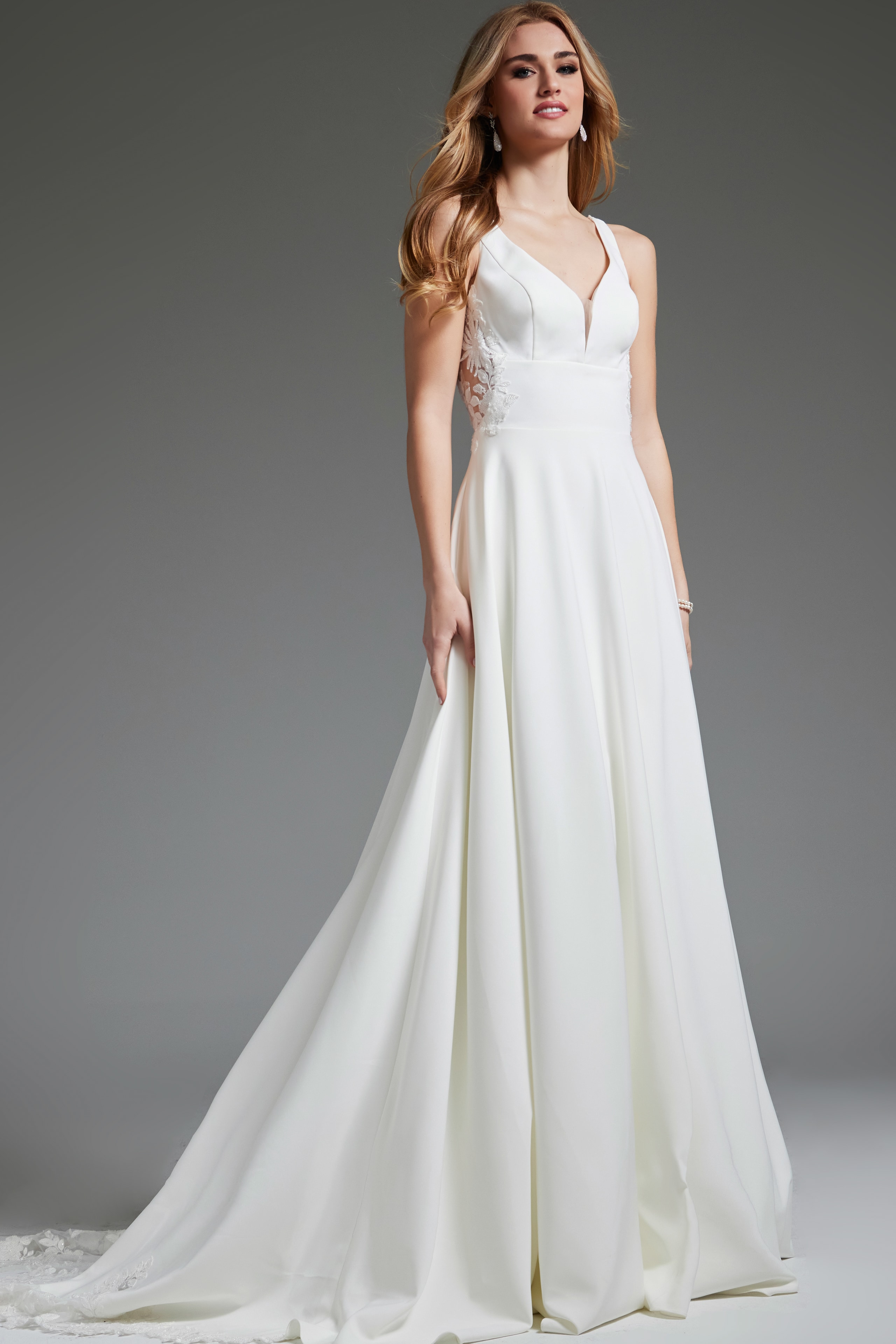 Model styled in Jovani JB42294 ivory dress, front view accentuating lace appliqués.