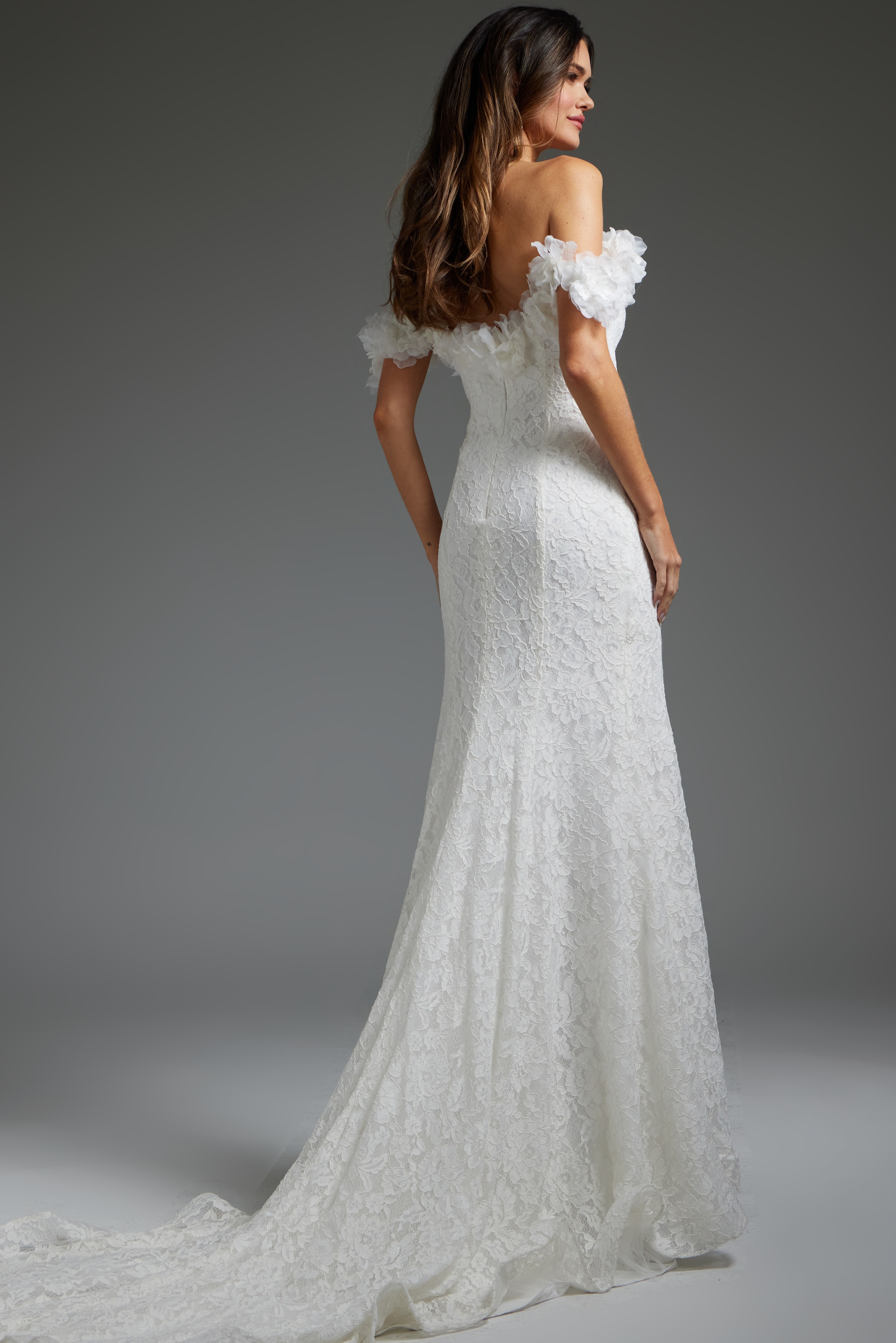 Back view of model in JB42295 ivory lace dress with off-shoulder design.