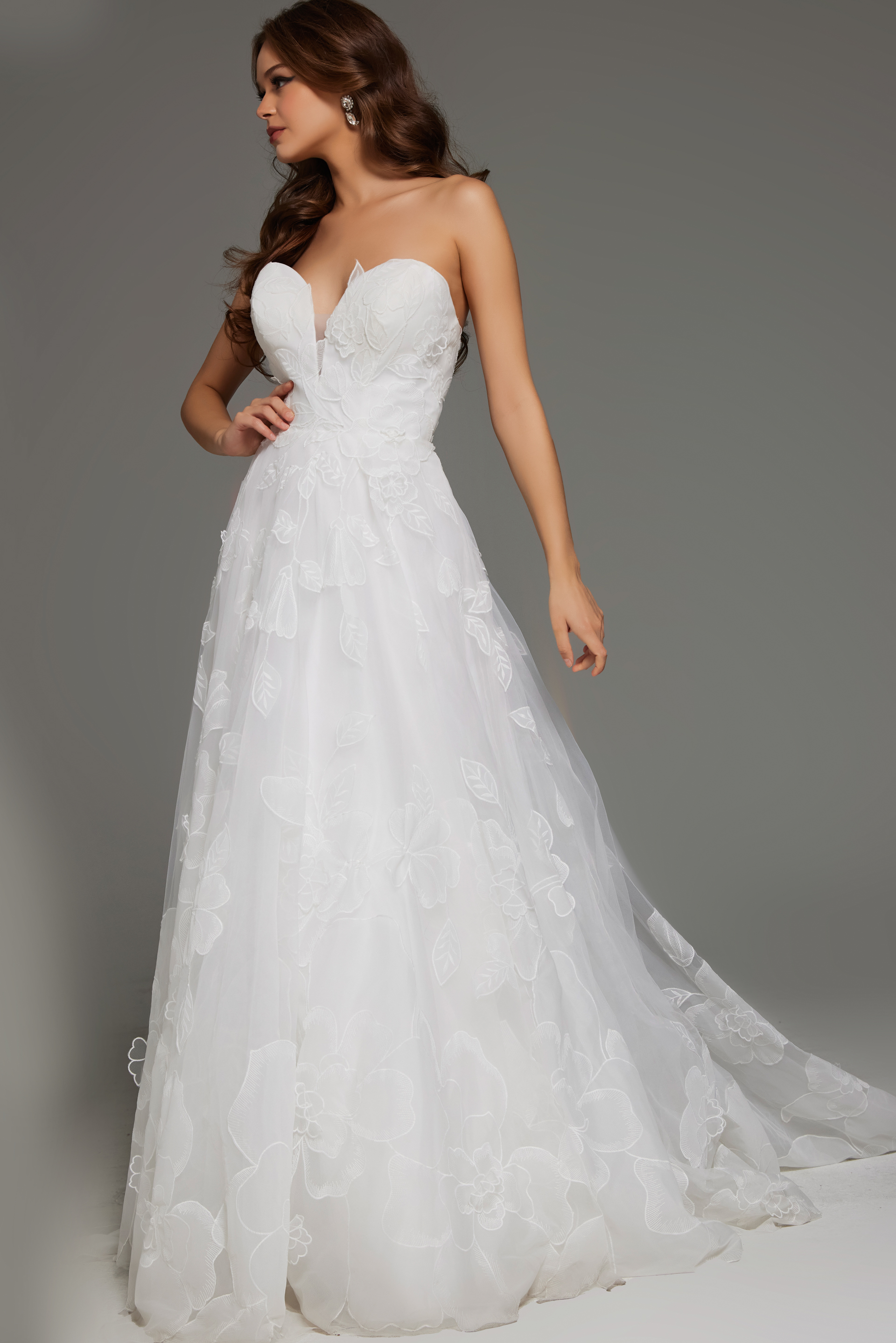 Front view of model wearing Jovani JB42324 ivory gown with floral appliques and sweetheart neckline.