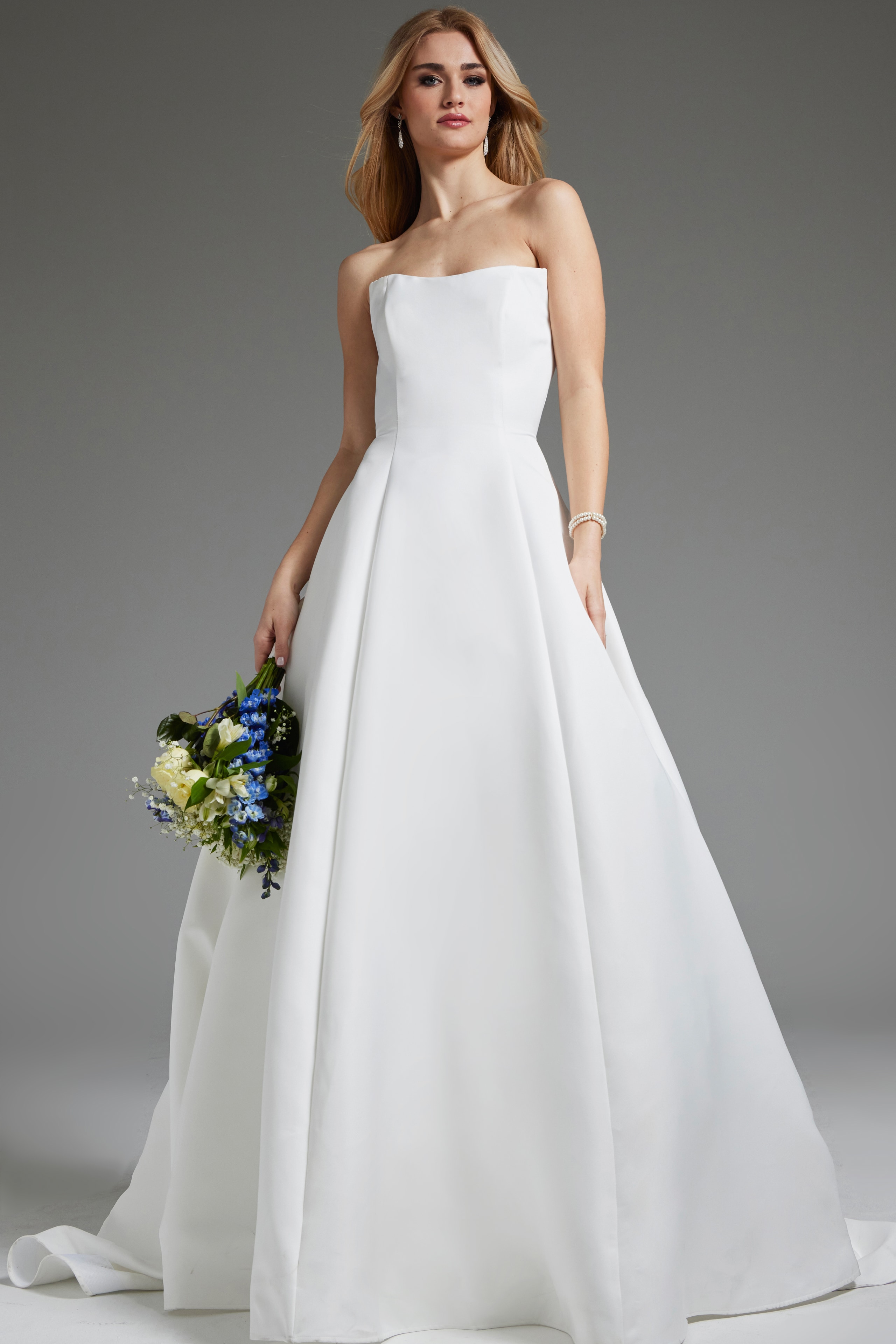 Model wearing Jovani JB42346 elegant off-white dress, front view.