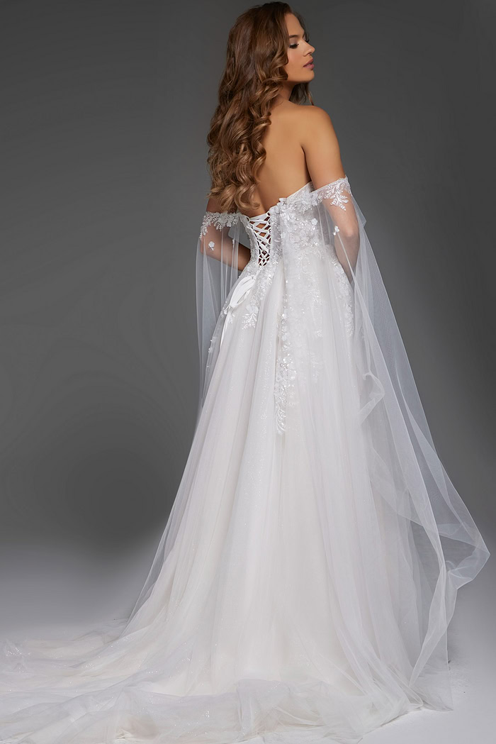 Model in Jovani JB42481 showcasing back of the white gown with sheer sleeves.