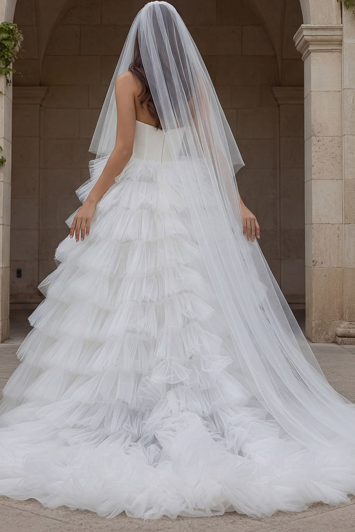 Back view of one shoulder tiered tulle wedding gown.