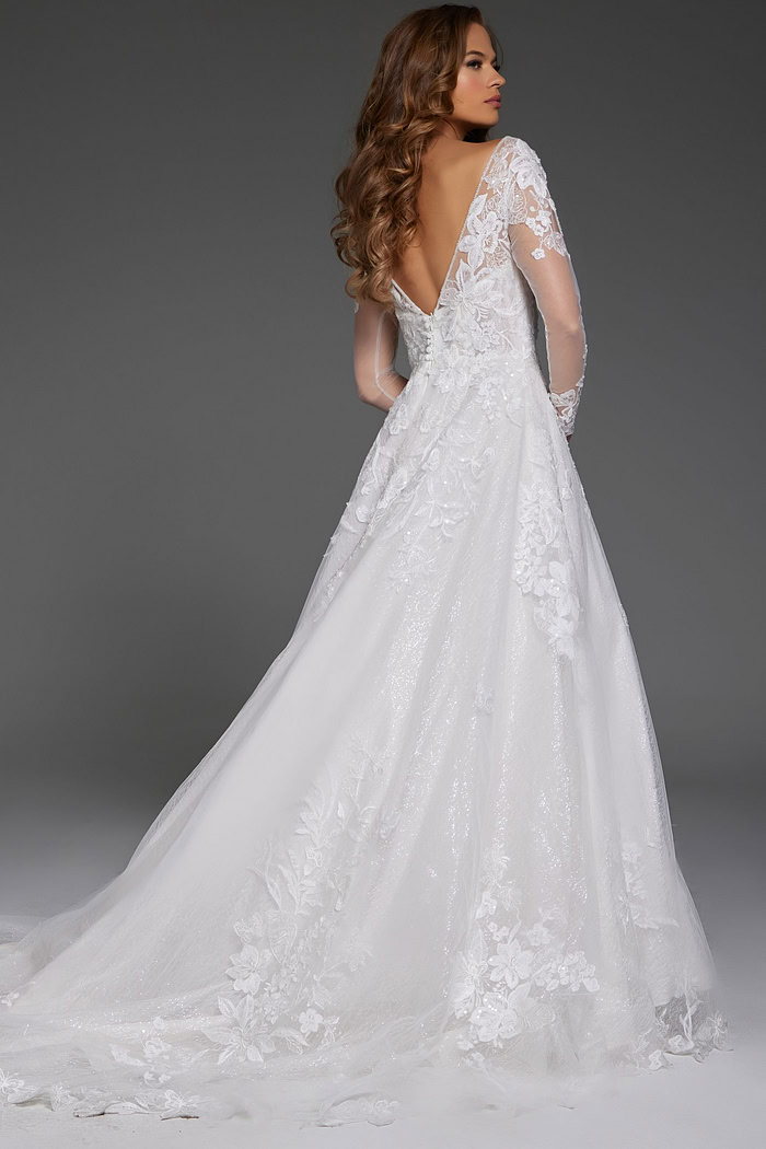 Back view of model in Jovani JB43317 ivory gown with floral lace and low V-back.