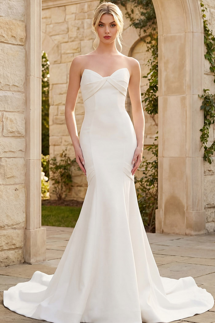 Elegant strapless mermaid wedding dress with soft sweetheart bodice and flowing train.