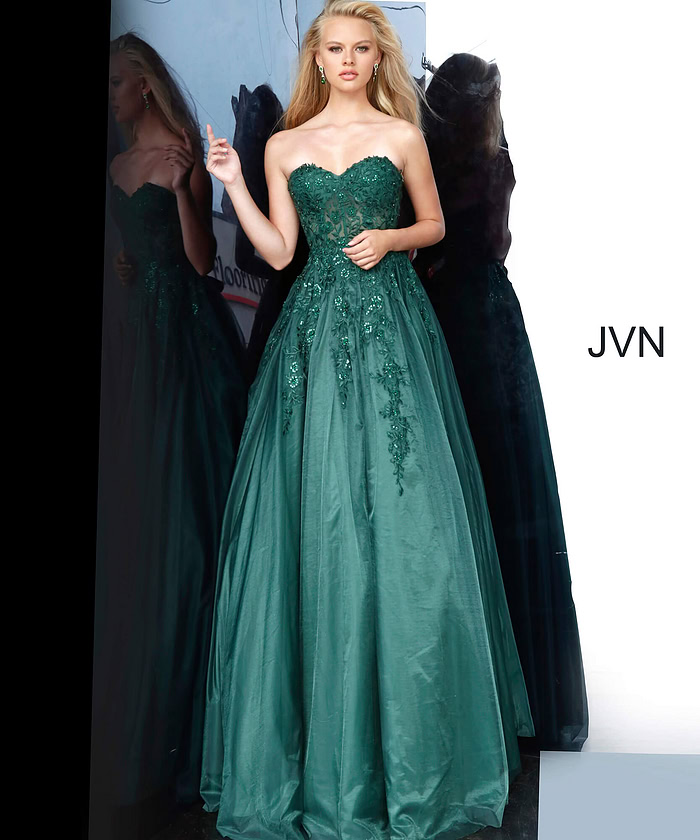 Model wearing Jovani 00915 green gown with elegant embroidery and flowing skirt.