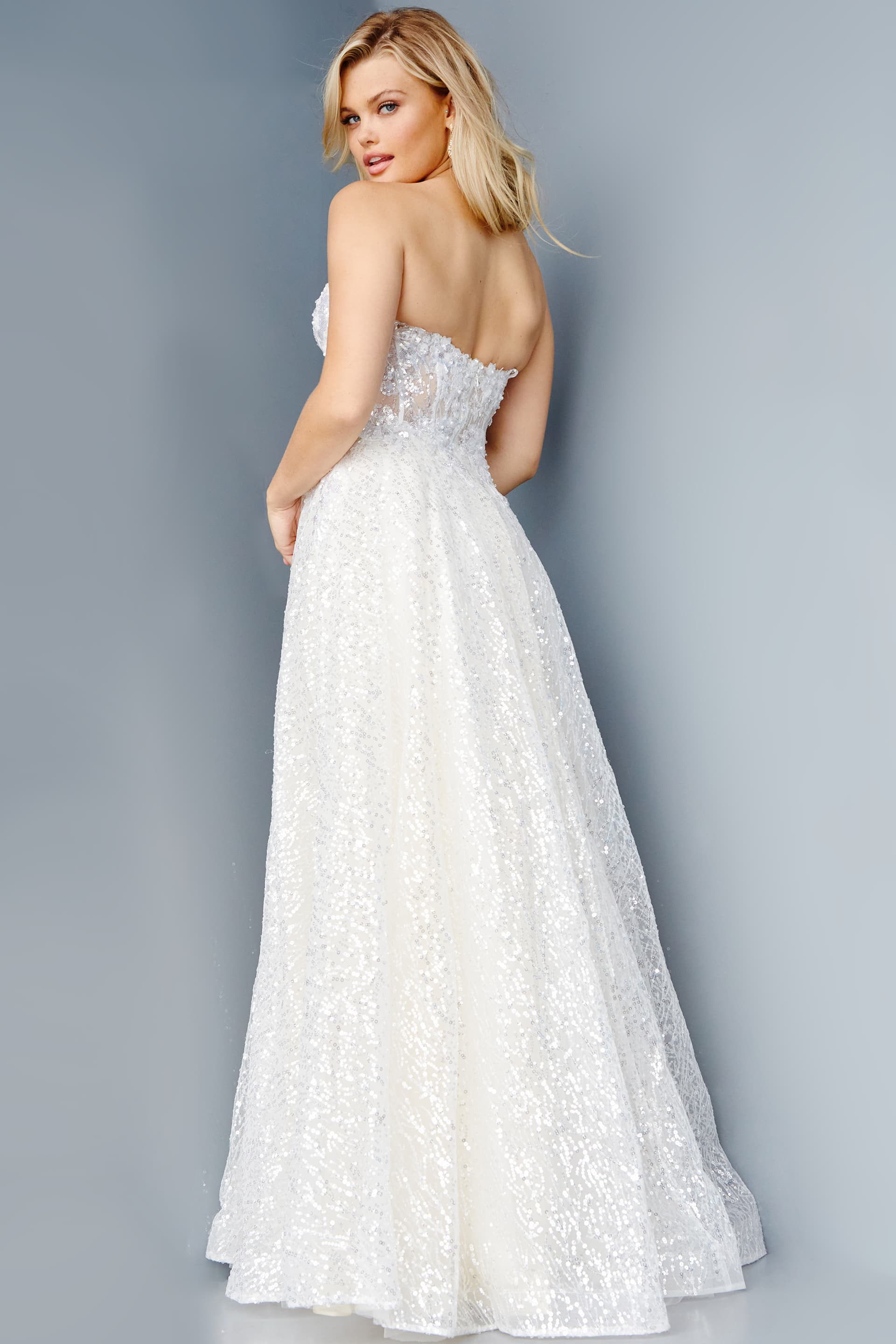 Back view of model wearing Jovani 08417 ivory dress with a sequin embellishment.