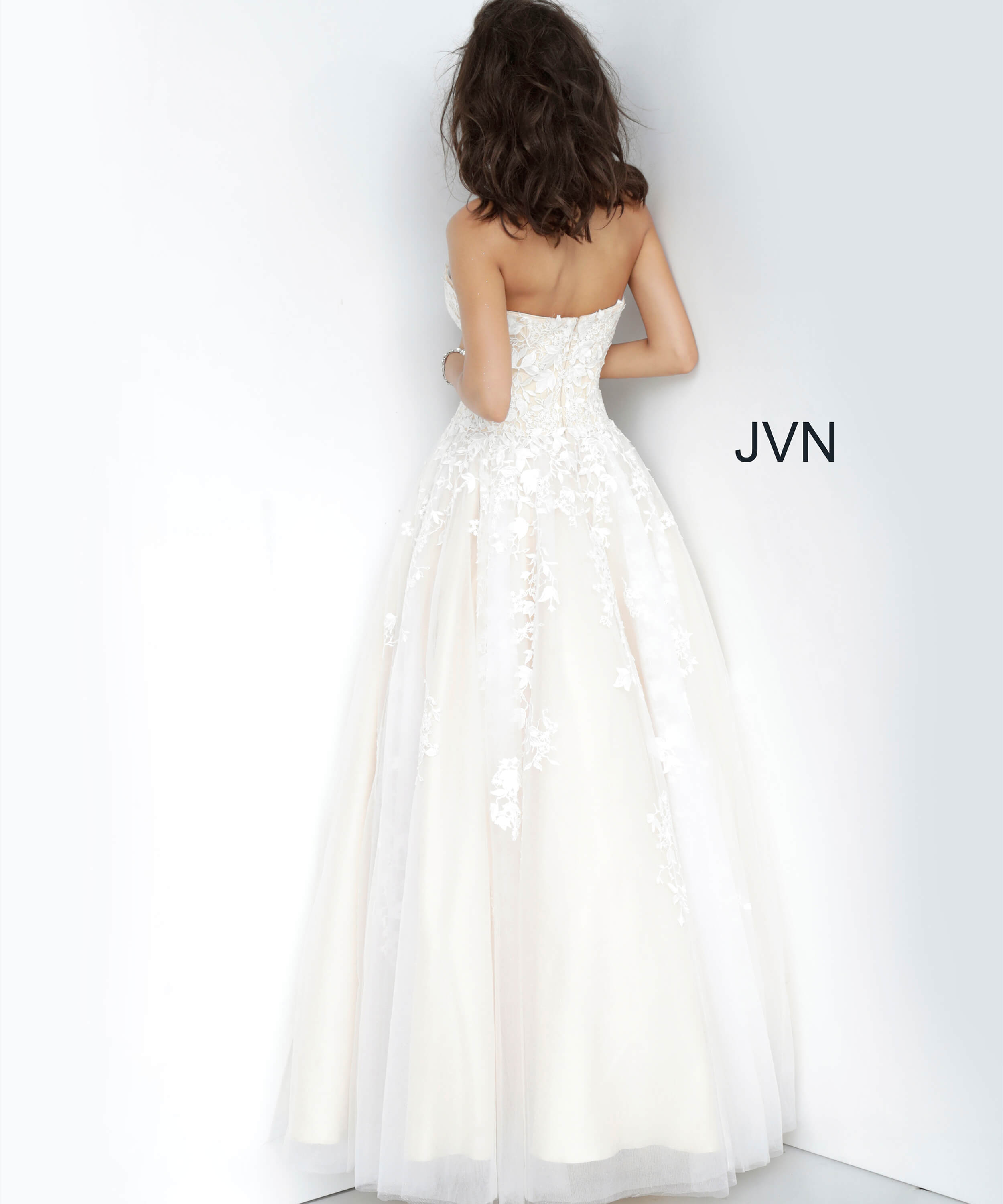 Model wearing Jovani 1831 ball gown in off-white, back view