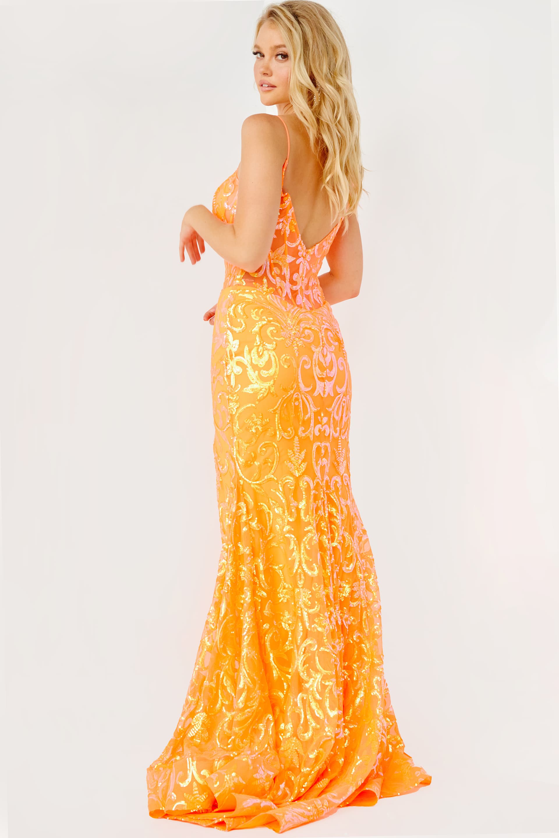 Model wearing Jovani 23216 orange dress, showcasing low back detail.