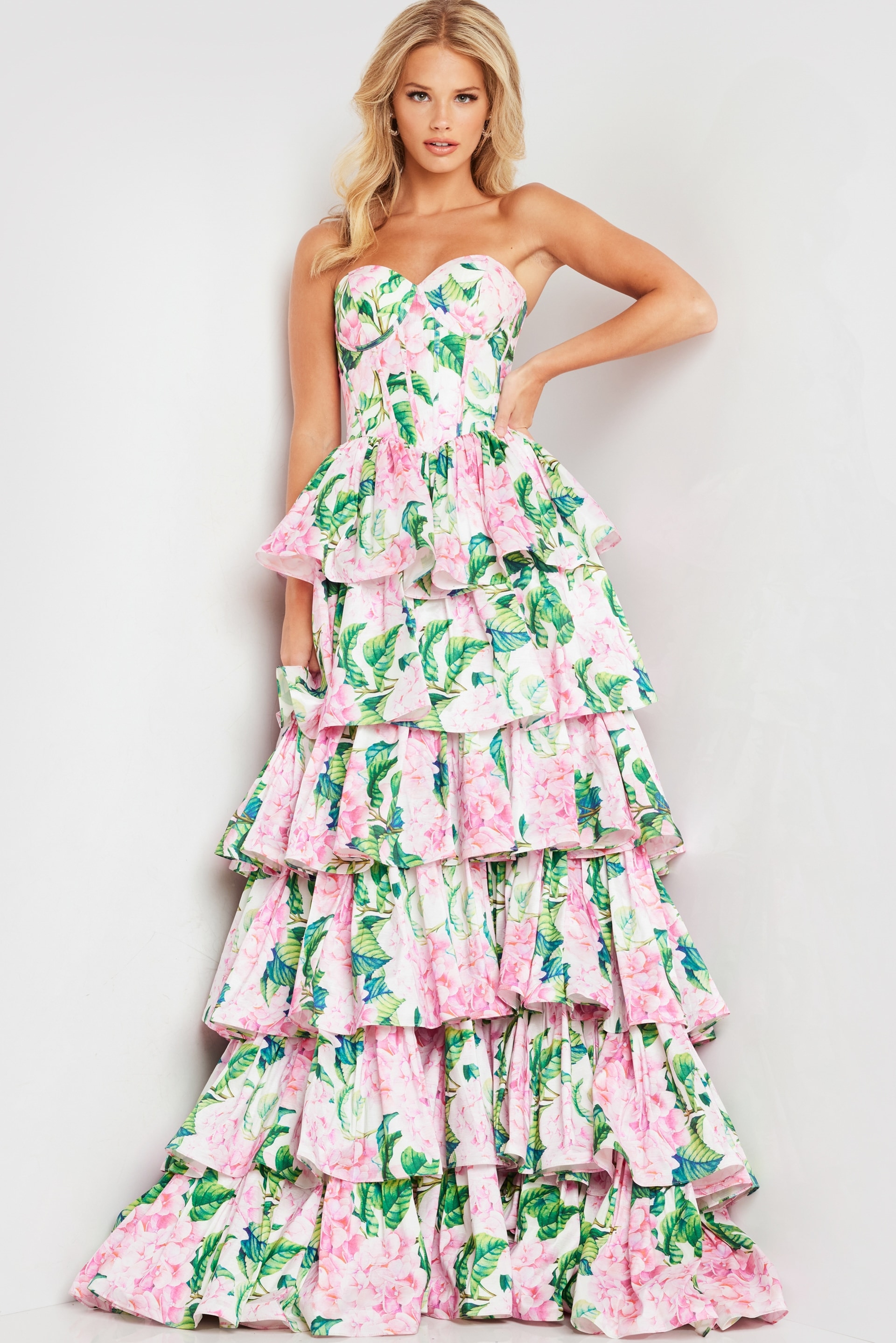 Model in Jovani 37058 dress, front view with floral design and tiered ruffles