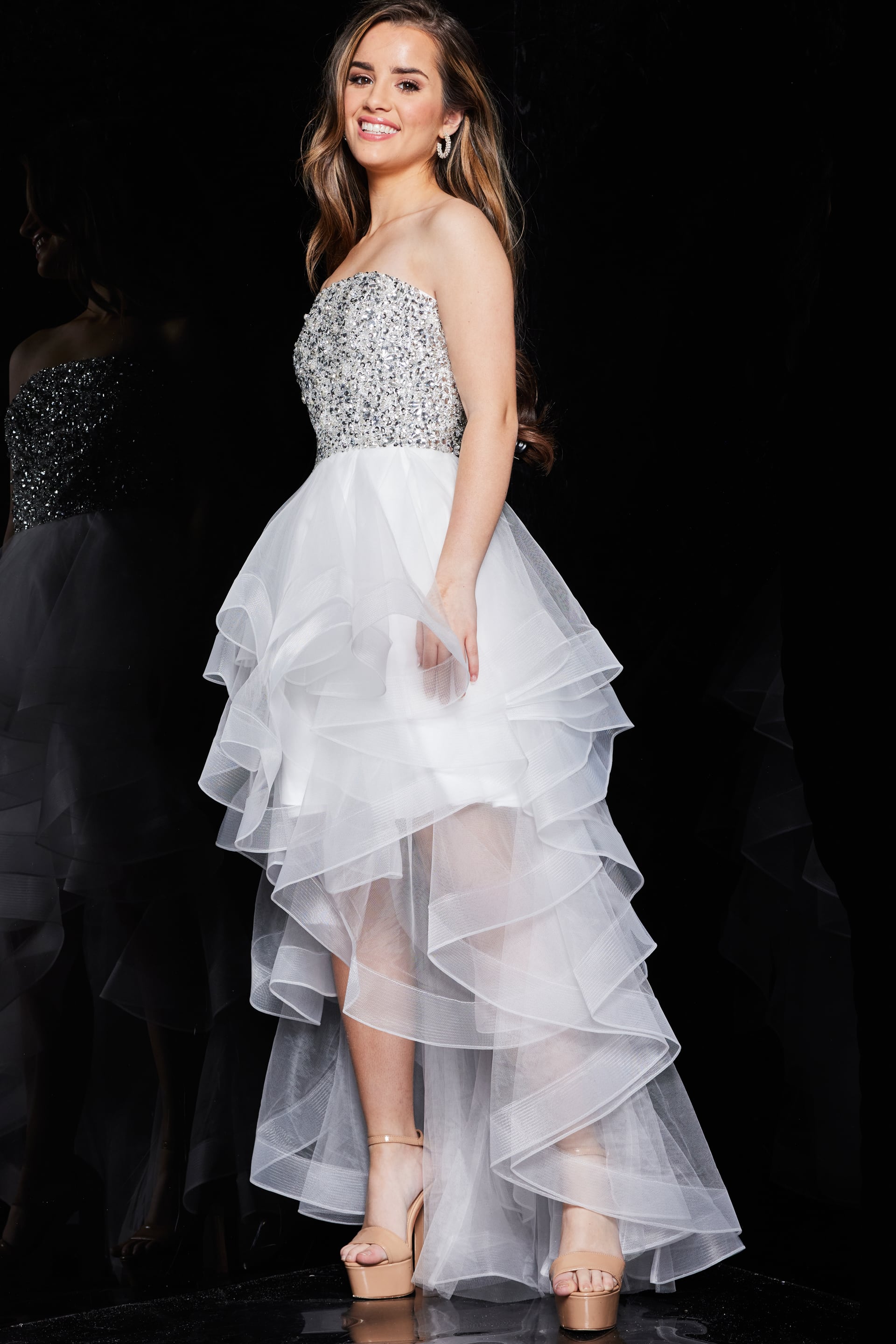 Model wearing Jovani K05916, showing the detailed sequin bodice and layered skirt, front view.