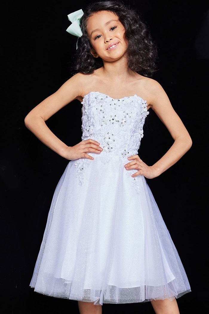 Child model in Jovani K07817 dress, white color with floral lace detailing, front view.