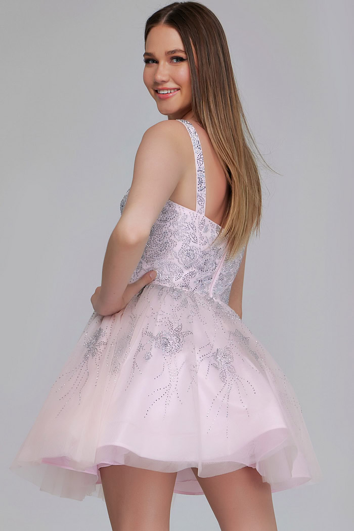 Model wearing K22943 pale pink dress, back view with sequin details.