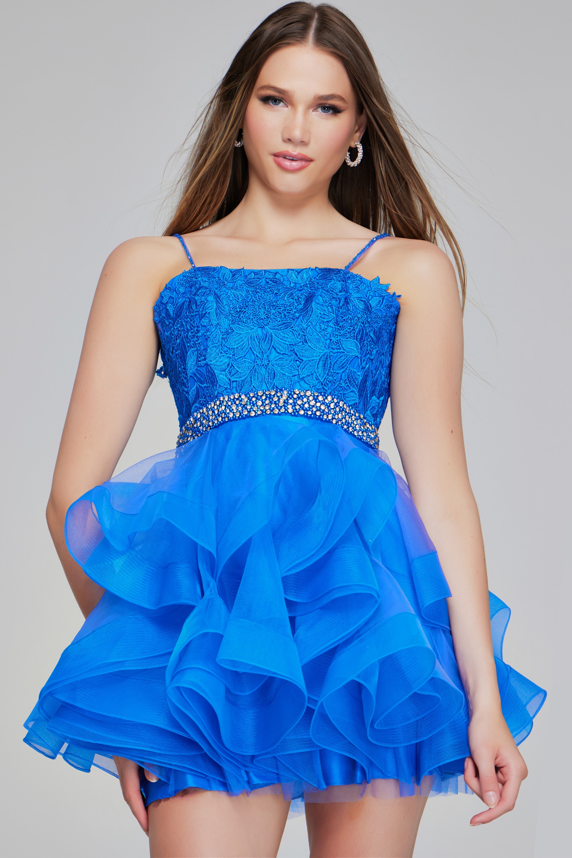 Model wearing Jovani K23518 blue dress with lace bodice and jeweled waist