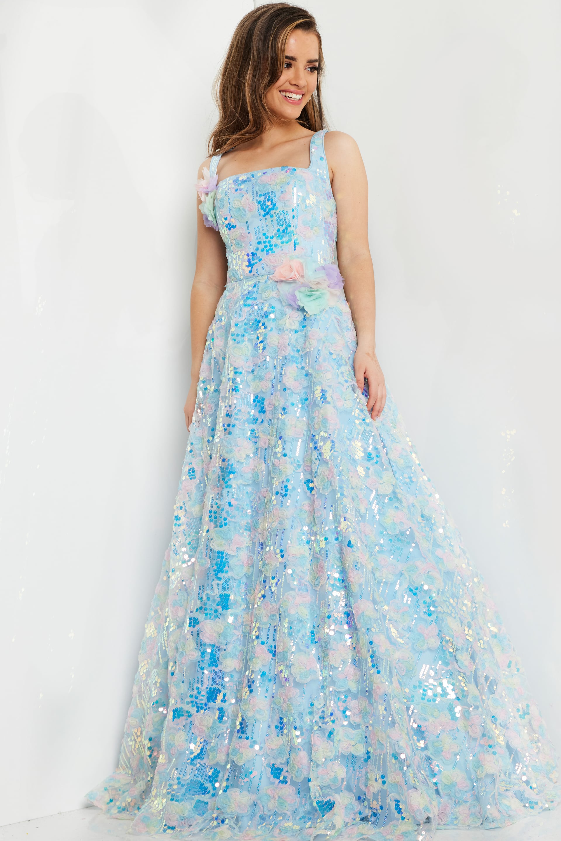Front angle view of model wearing K23955 gown featuring floral embellishments.